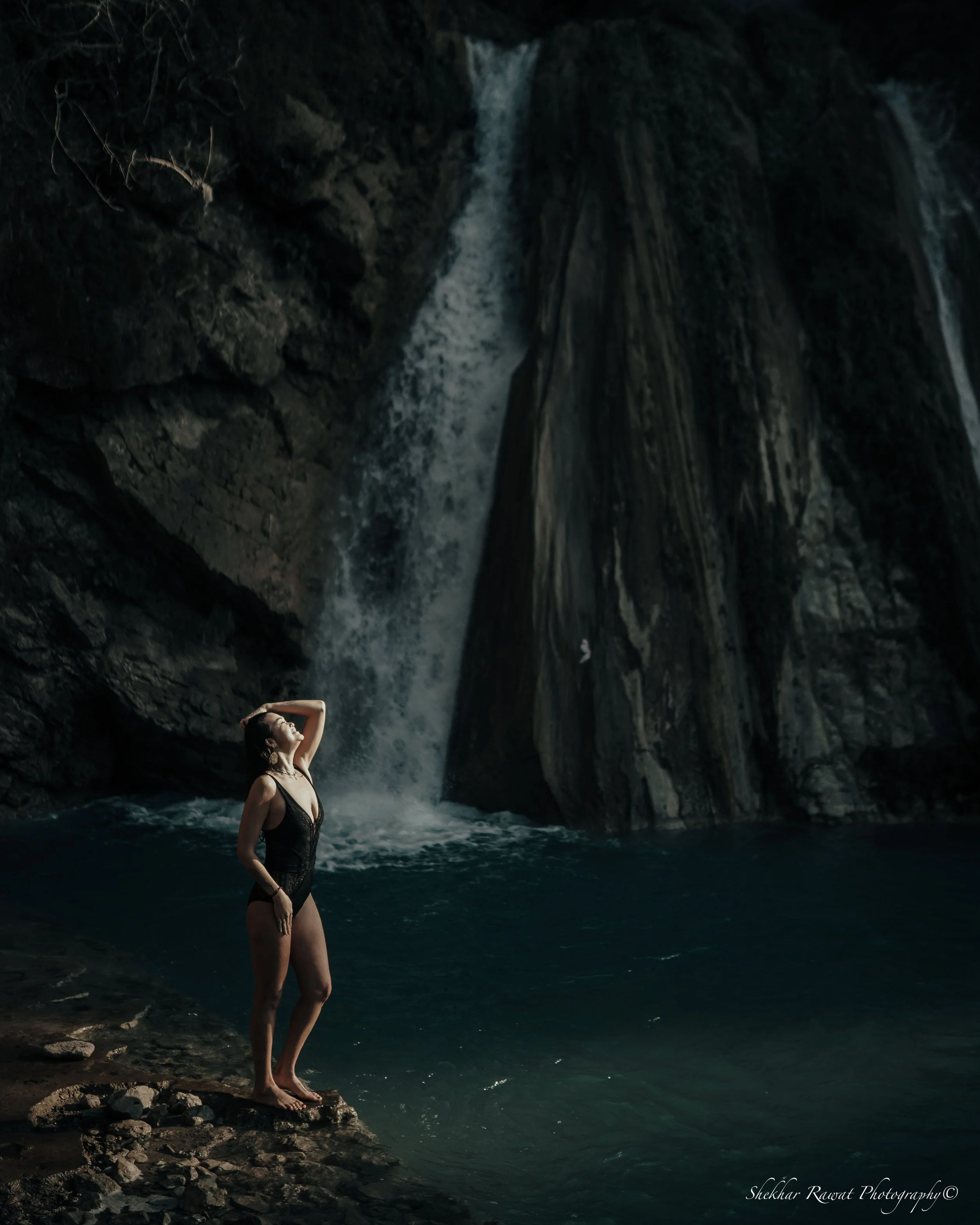 Model in a black swimsuit by a waterfall, swimwear fashion shoot by Melbourne photographer Shekhar Rawat