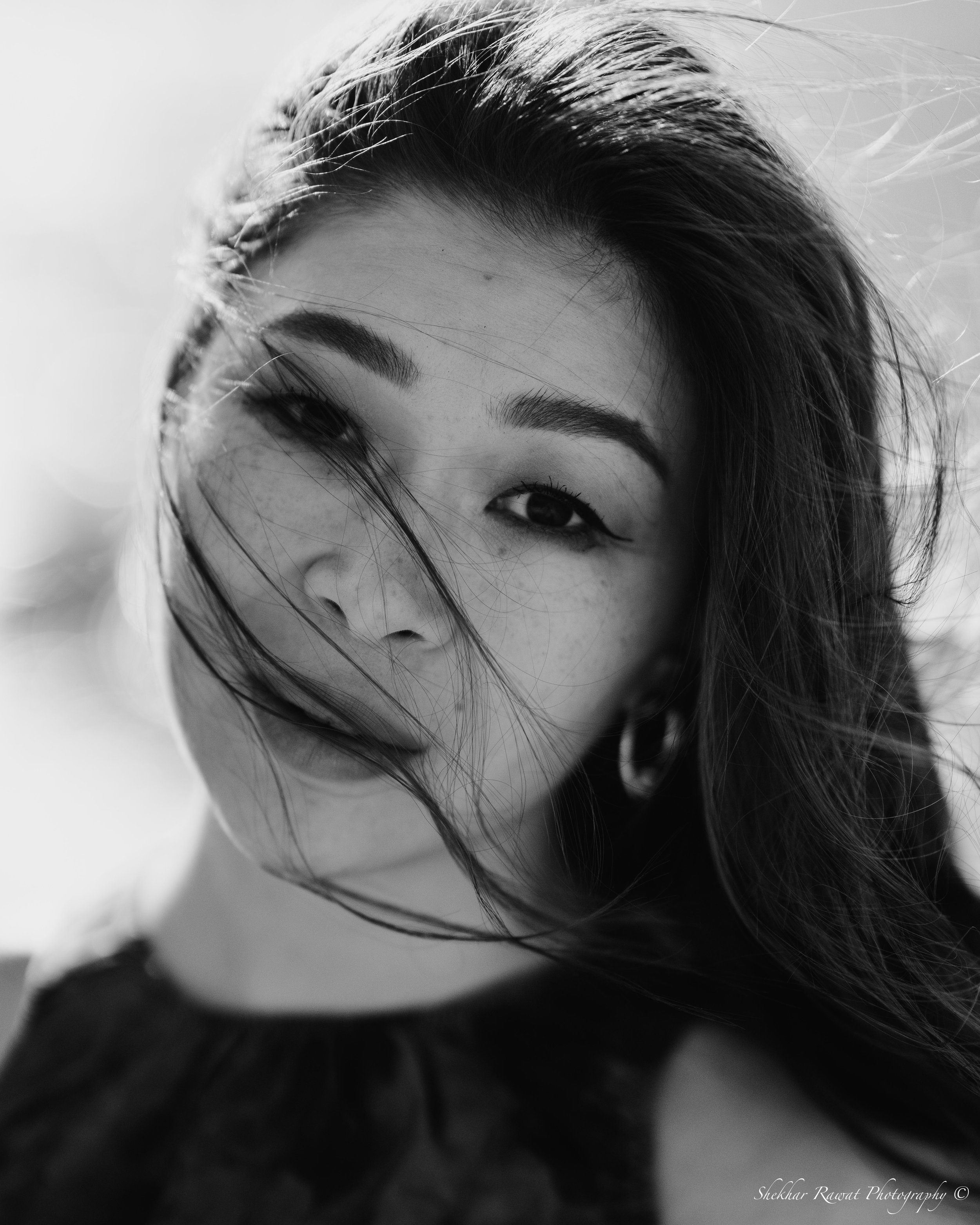 Black and white close-up portrait with windswept hair, portrait photography in Melbourne by Shekhar Rawat