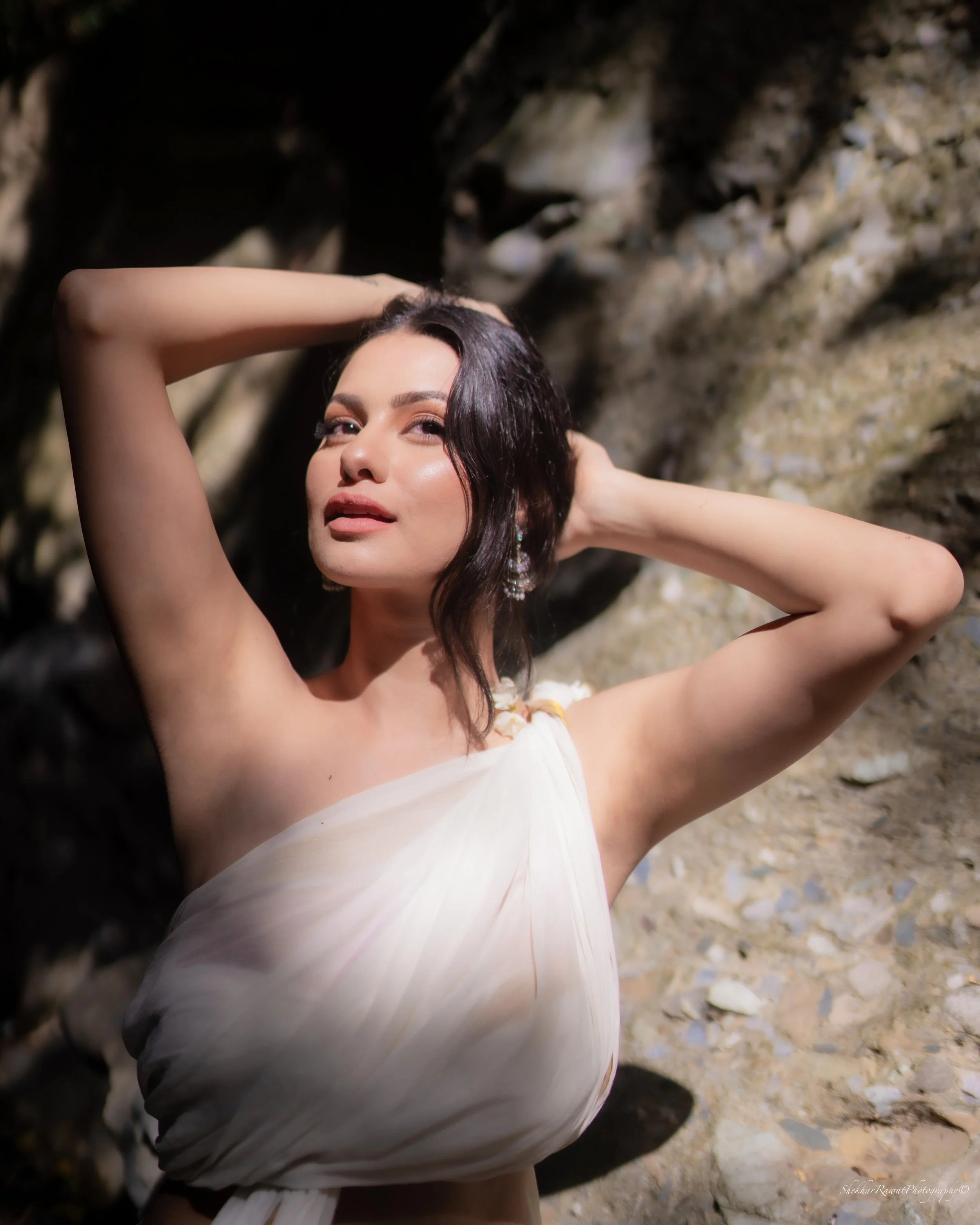 Model Sakshi Joshi in a white dress among rocks, conceptual shoot by Shekhar Rawat