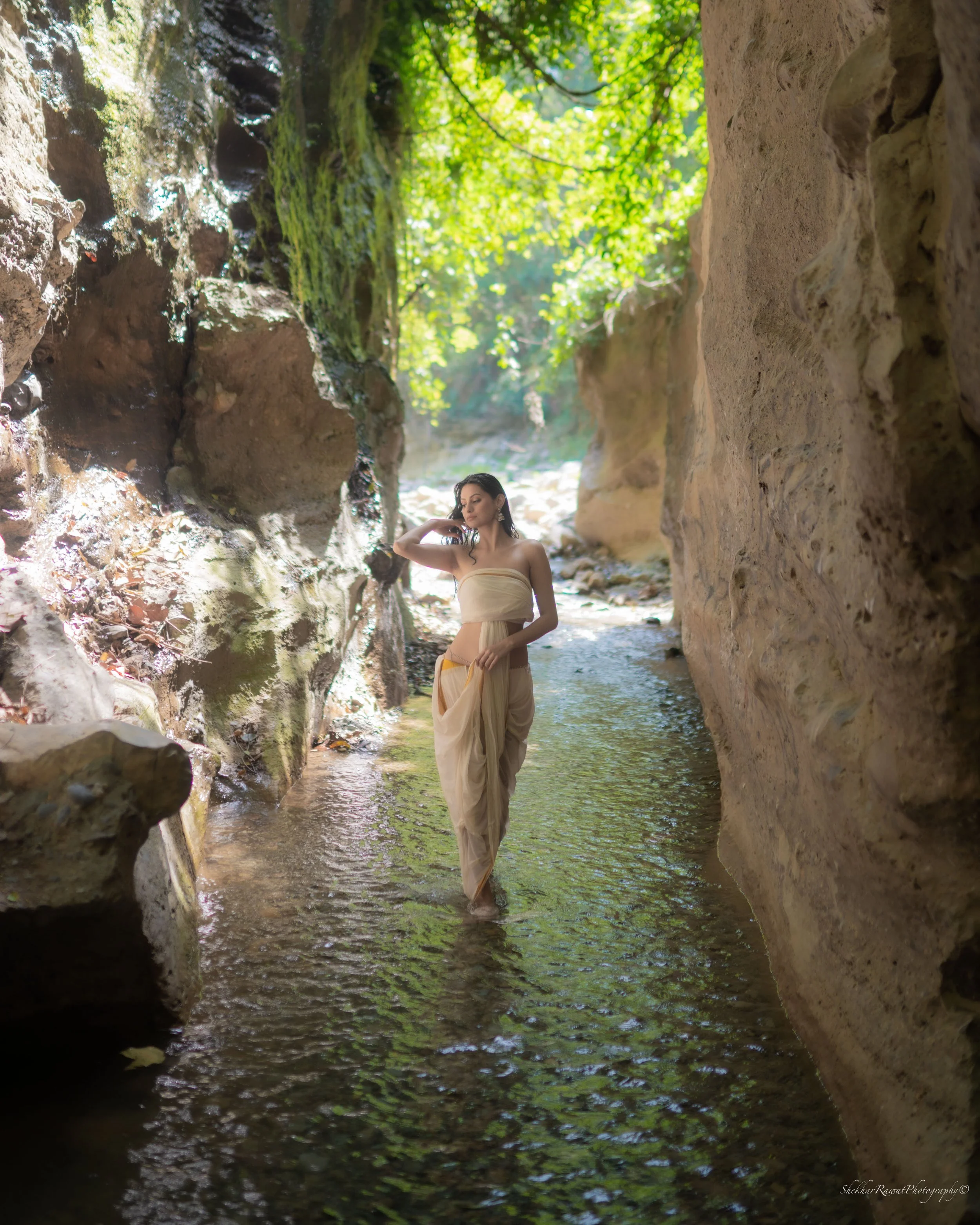 Model standing in a mossy rock gorge stream, outdoor fashion shoot by Melbourne photographer Shekhar Rawat