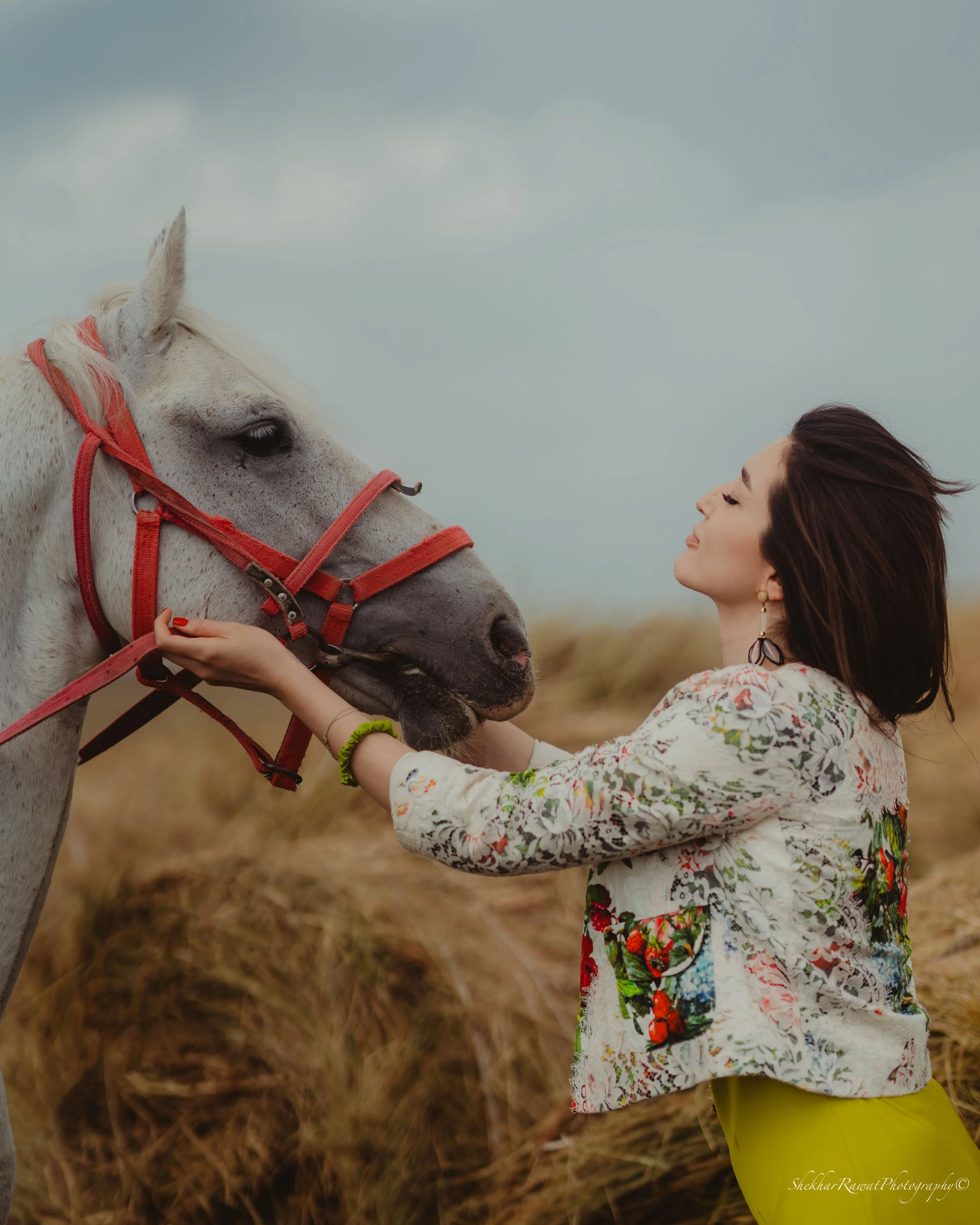 Model with a white horse in a field, outdoor portrait by Melbourne photographer Shekhar Rawat