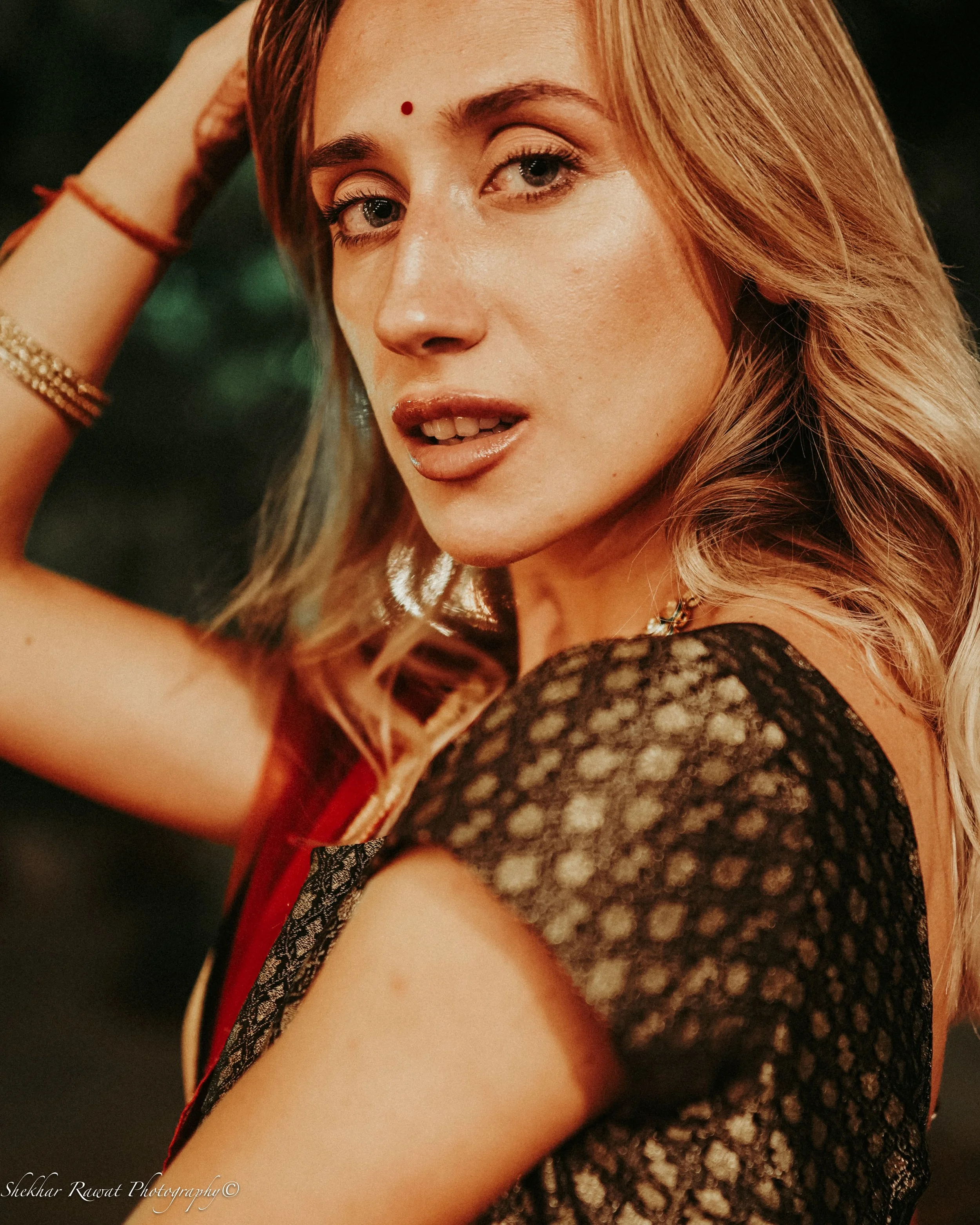 Model with red-blonde hair, a bindi and black and red lace, fusion fashion portrait by Melbourne photographer Shekhar Rawat
