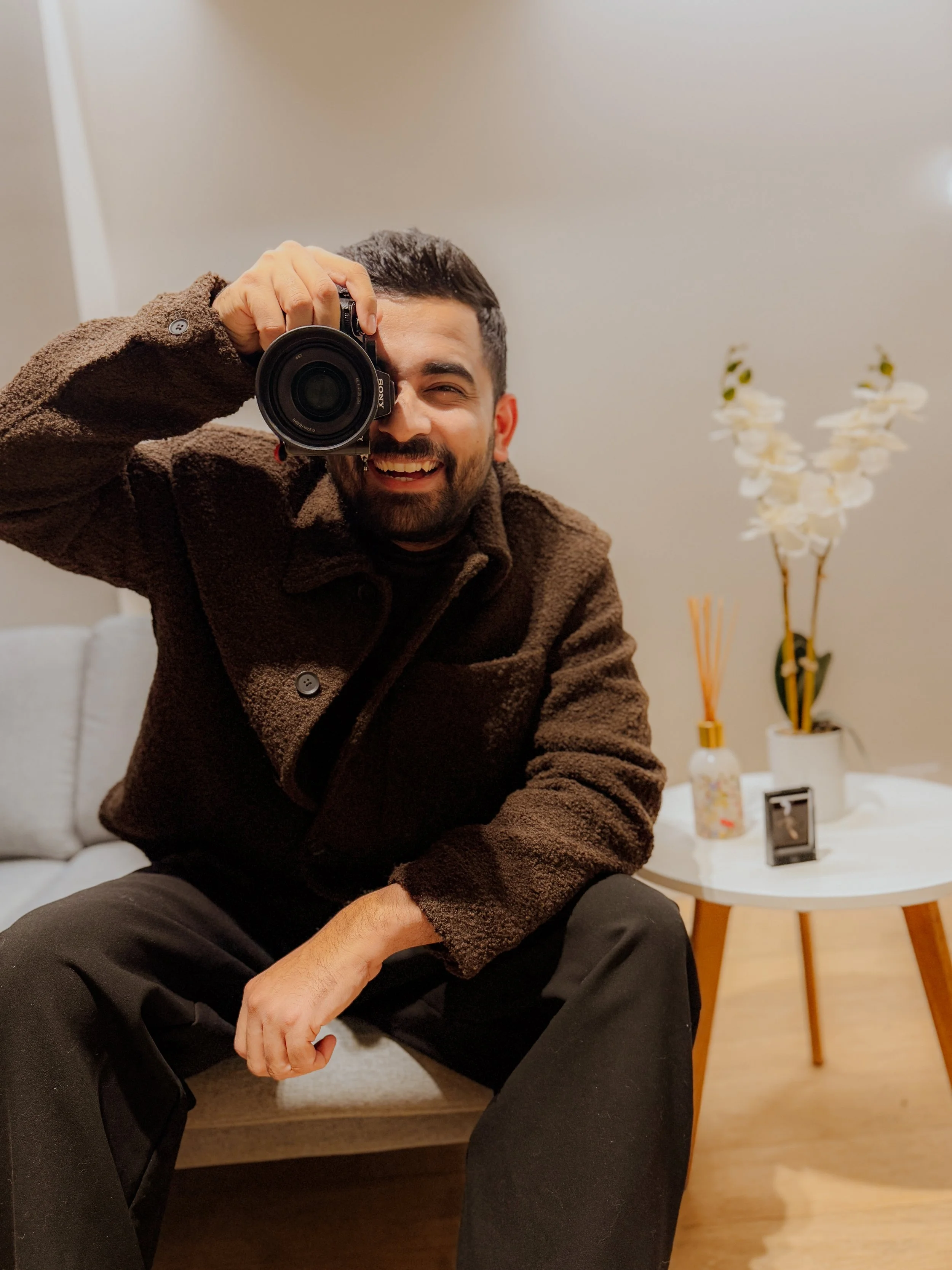 Shekhar Rawat, Melbourne photographer and filmmaker, holding his camera at home