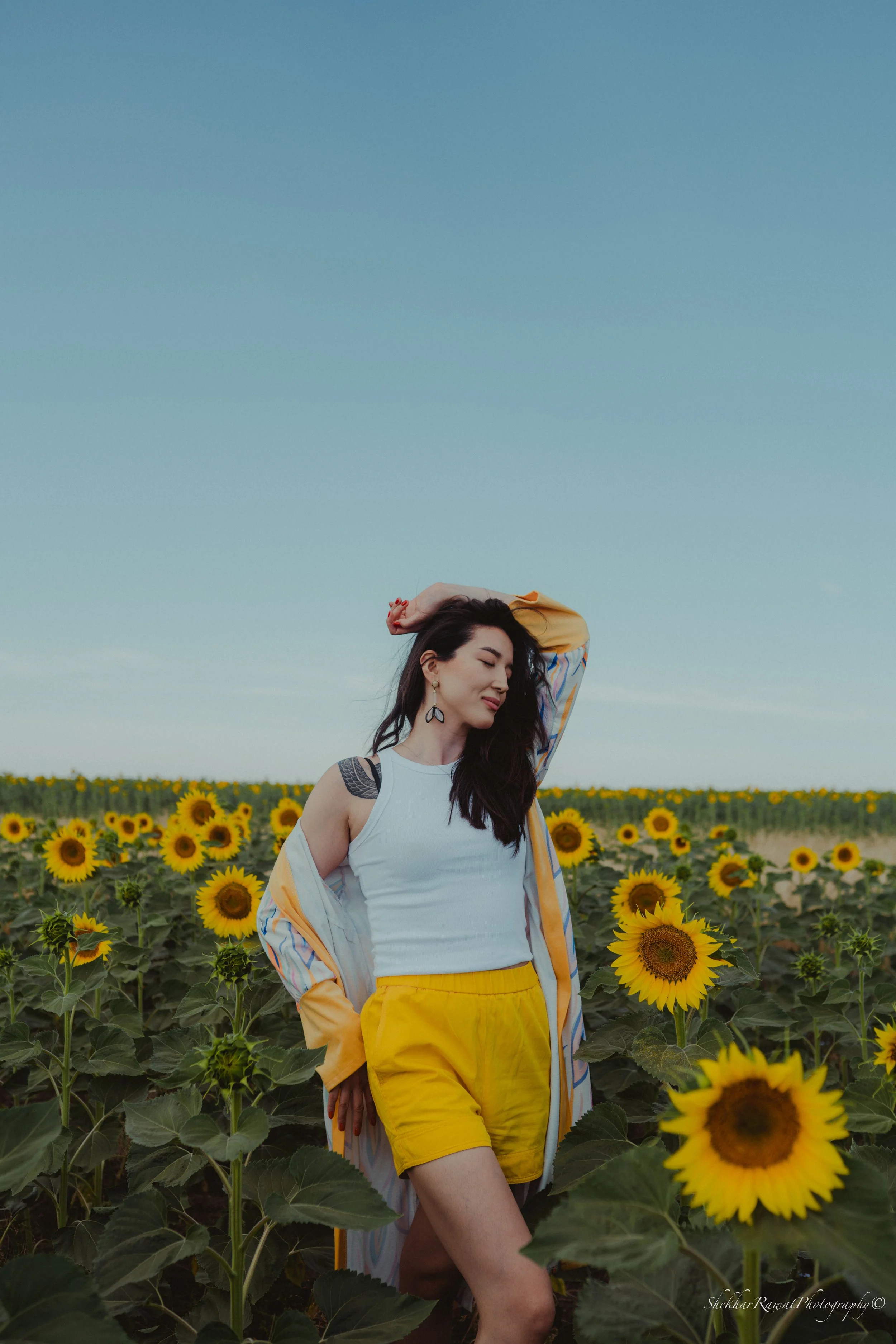 Model in a colourful jacket in a sunflower field, summer fashion shoot by Melbourne photographer Shekhar Rawat