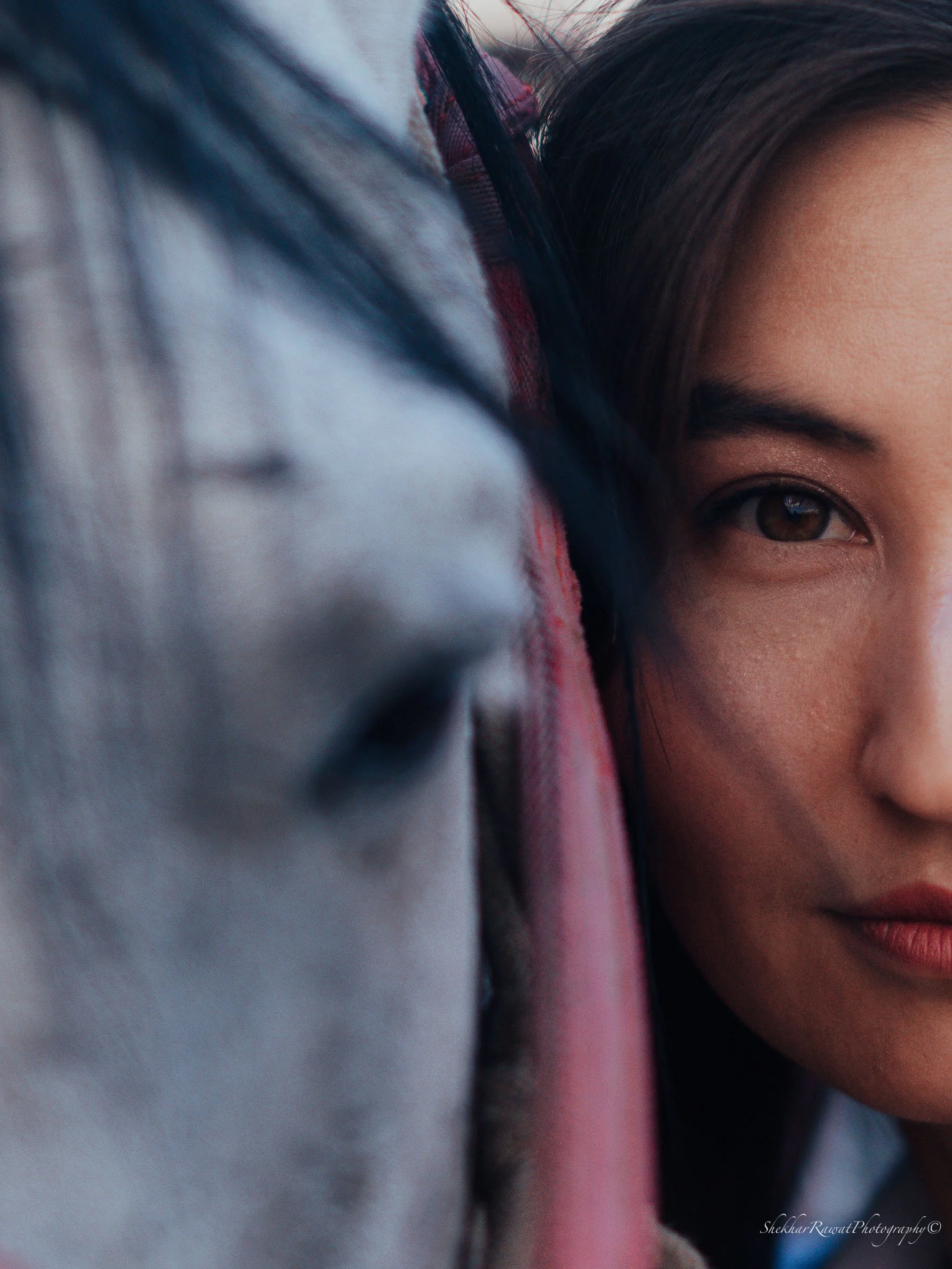 Soft close-up beauty portrait resting on grey fabric, portrait photography by Melbourne photographer Shekhar Rawat