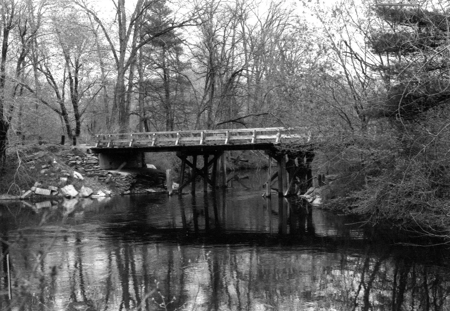 A historic photo of a wooden bridge.
