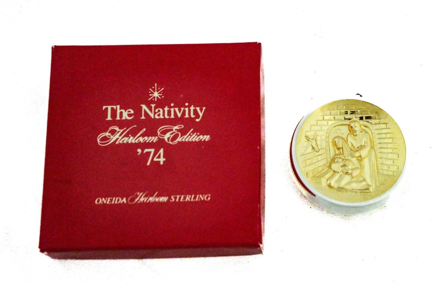 The item is a 1974 Oneida Heirloom Sterling Christmas Ornament titled &ldquo;The Nativity.&rdquo;
It comes in its original red presentation box marked:
	&bull;	&ldquo;The Nativity &ndash; Heirloom Edition &rsquo;74&rdquo;
	&bull;	&ldquo;Oneida Heirlo