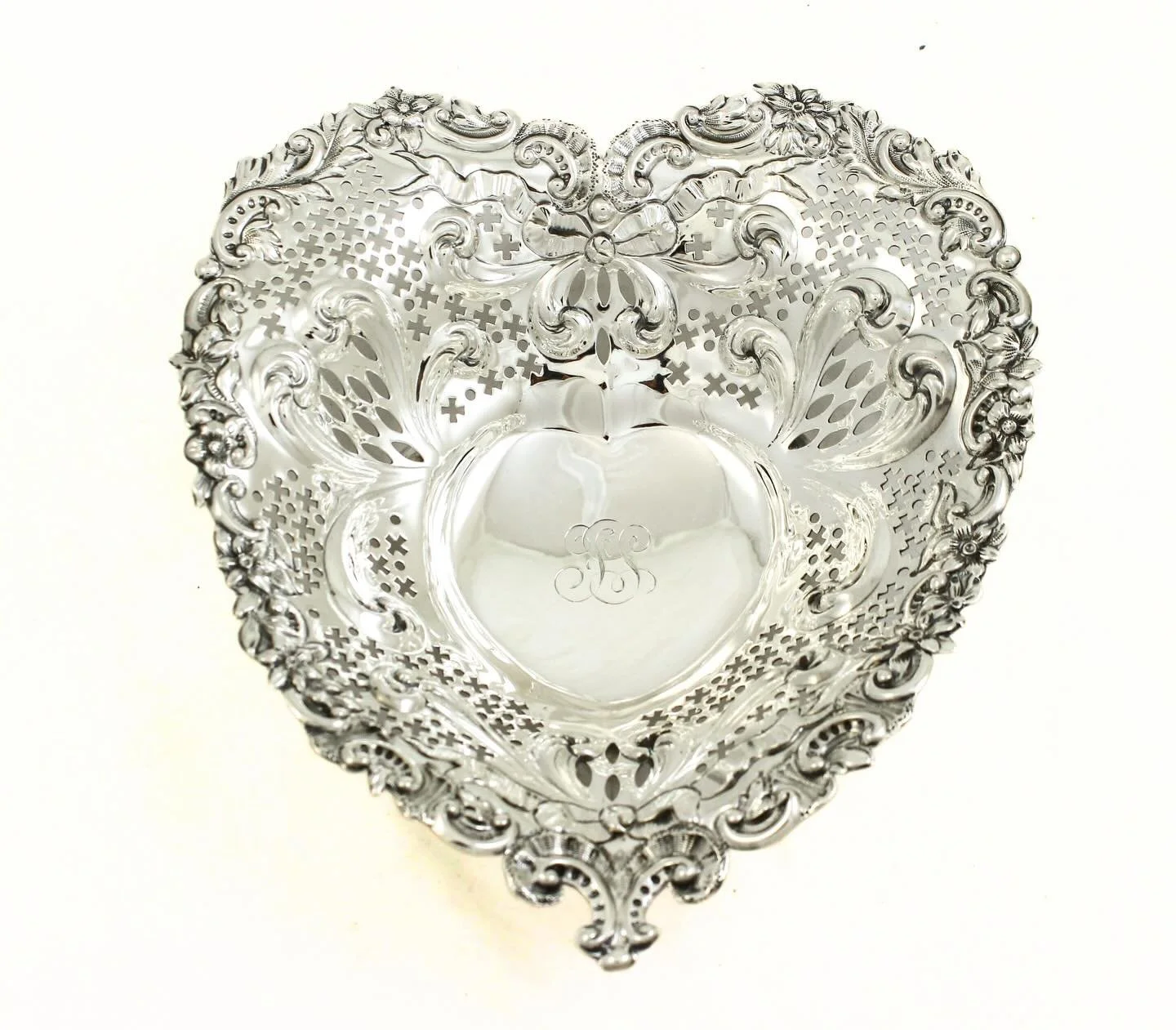 Love, but make it sterling. 💘
This exquisite heart-shaped sterling silver dish is pure romance in metal form&mdash;pierced and chased with lush Rococo scrolls, florals, and flowing foliage, all framing a smooth central reserve ready for a special mo