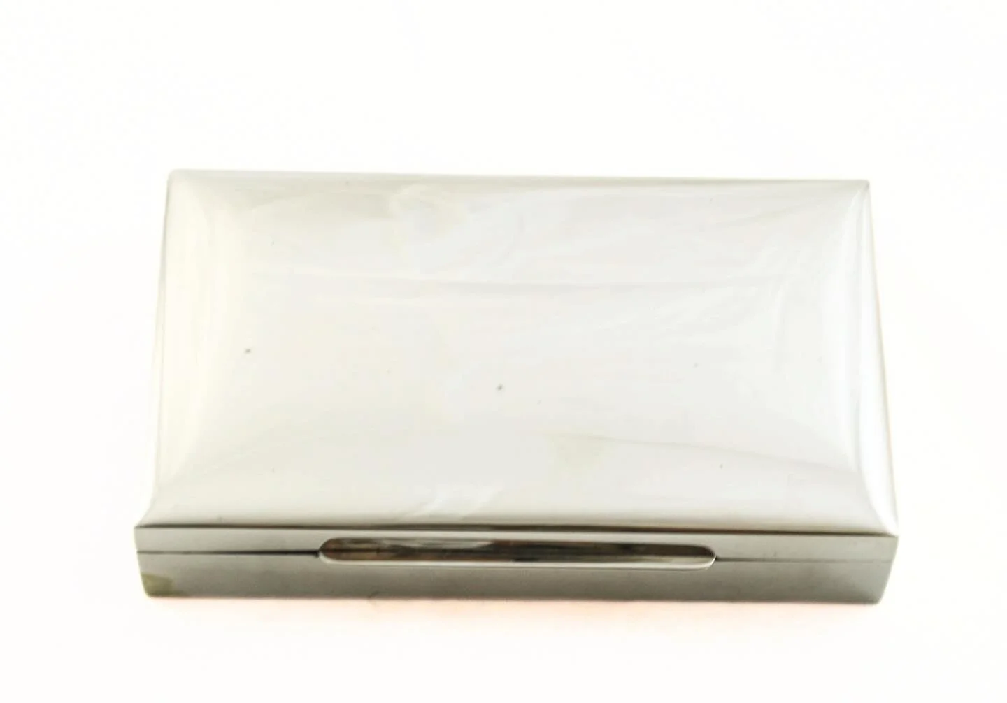 A refined sterling silver gentleman&rsquo;s jewelry box, marked STERLING .925, with a clean, architectural silhouette and subtle curved lid. The understated exterior opens to a rich wood-lined interior&mdash;warm against the cool sheen of silver.
Min