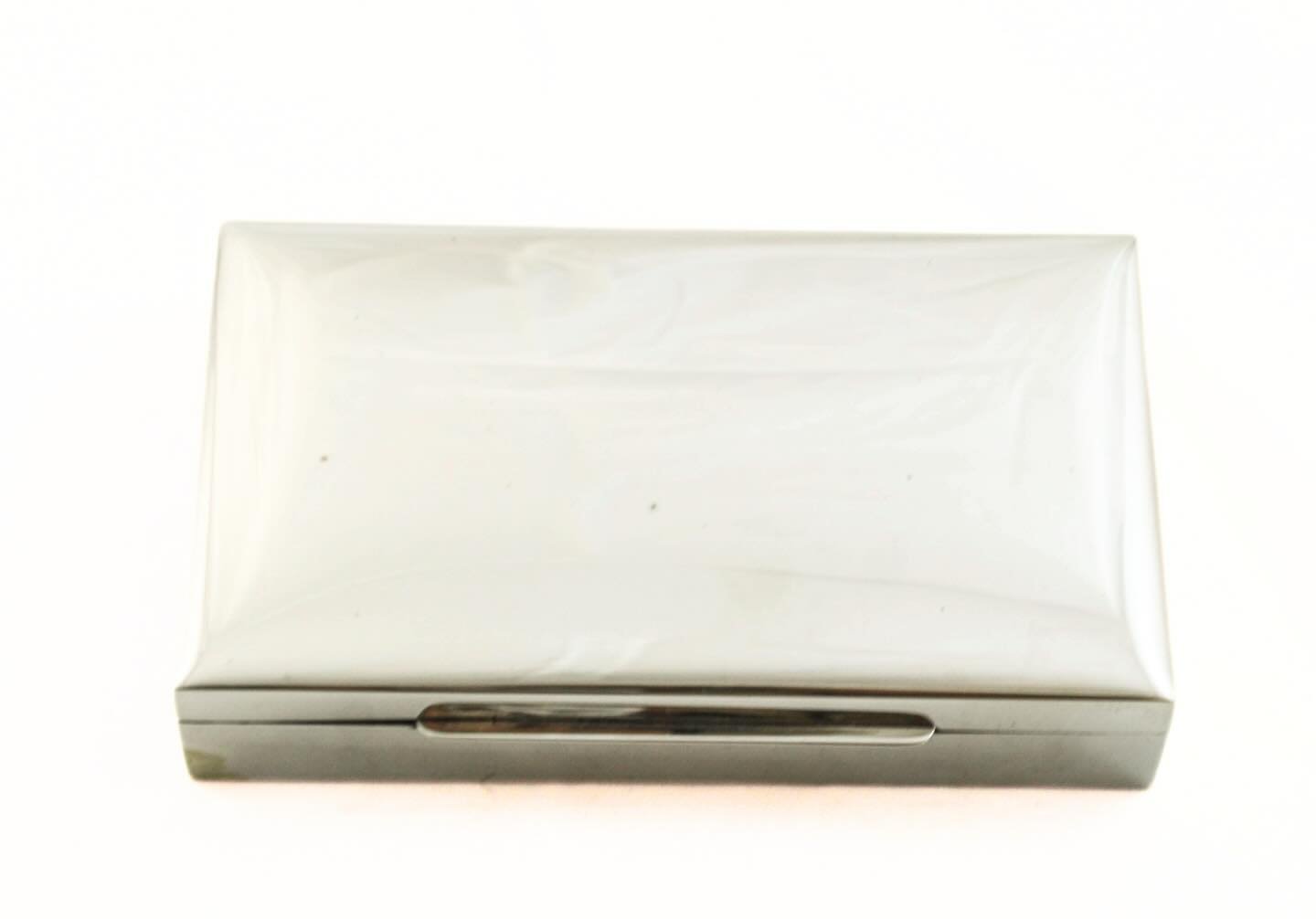 A refined sterling silver gentleman&rsquo;s jewelry box, marked STERLING .925, with a clean, architectural silhouette and subtle curved lid. The understated exterior opens to a rich wood-lined interior&mdash;warm against the cool sheen of silver.
Min