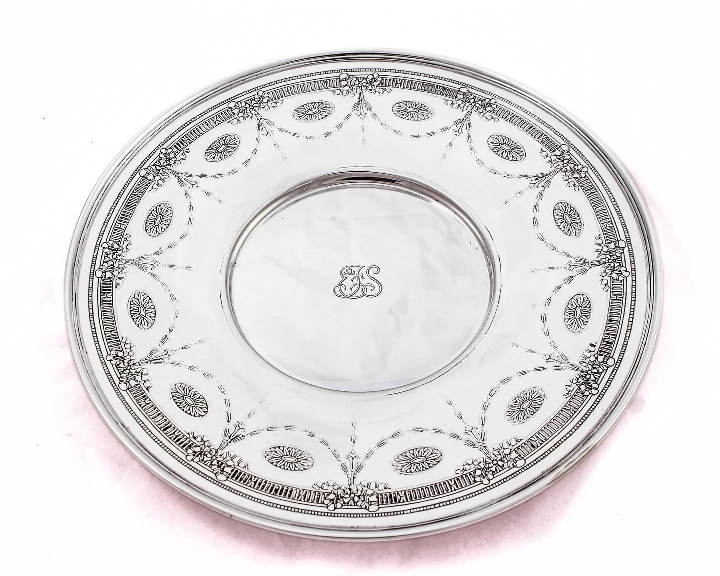 A statement piece from America&rsquo;s most celebrated silversmith, this large sterling silver dish by Tiffany &amp; Co. brings timeless elegance to any setting. Crafted in solid sterling silver, the dish features a refined neoclassical border of gar