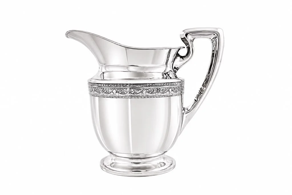 Fresh from the silversmith and shining exactly as sterling silver should.

This elegant sterling silver water pitcher combines graceful form with refined craftsmanship, featuring a beautifully sculpted handle, flowing spout, and an intricate decorati