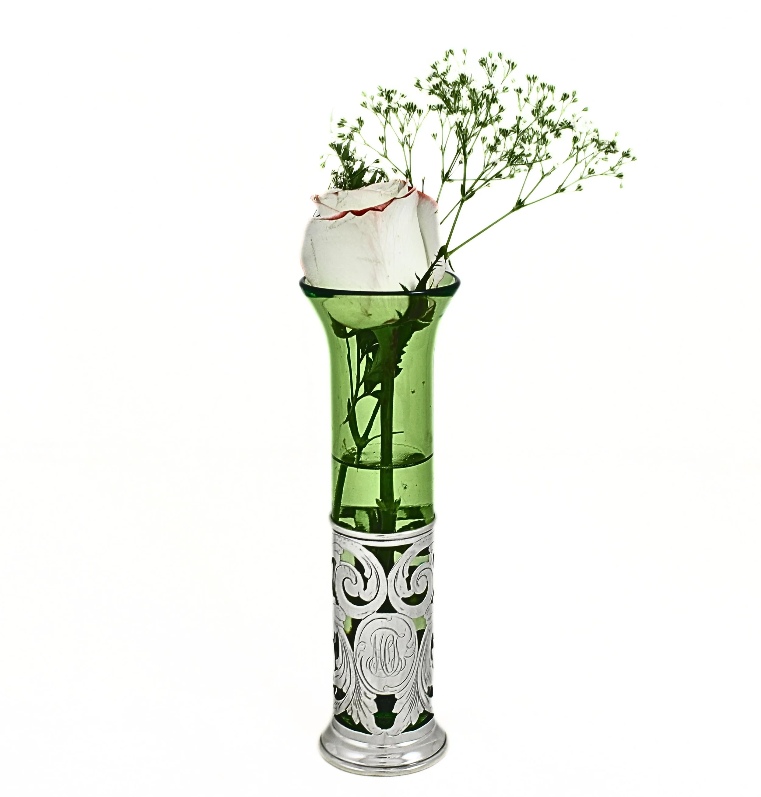 Fresh from the silversmith and glowing in rich grass-green glass, this elegant sterling silver bud vase by Theodore B. Starr is a beautiful example of early 20th century design and craftsmanship. The removable green glass liner is housed within a fin