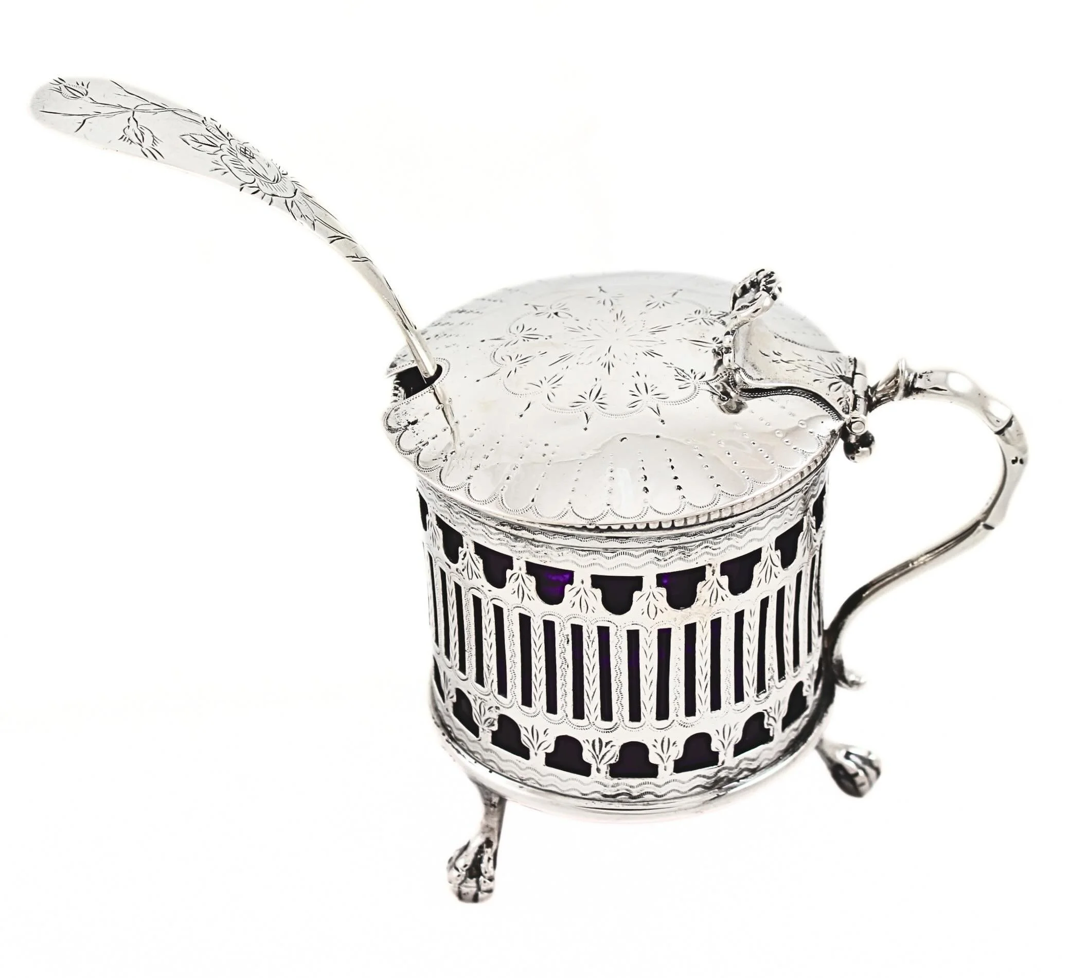 A touch of elegance for the Victorian table.

This exceptional Victorian sterling silver condiment jar features a beautifully pierced body, intricate hand engraving, and its original cobalt blue glass liner&mdash;creating a striking contrast between 