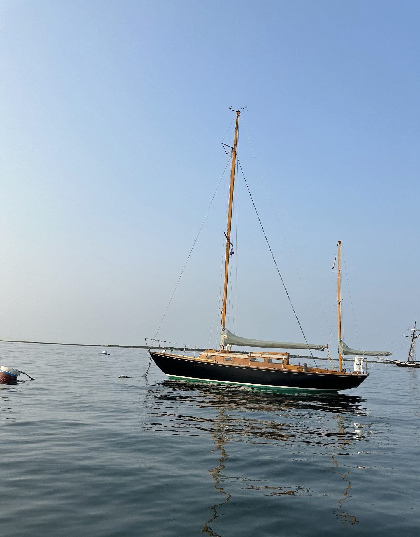 Sailboat on calm water under a clear blue sky