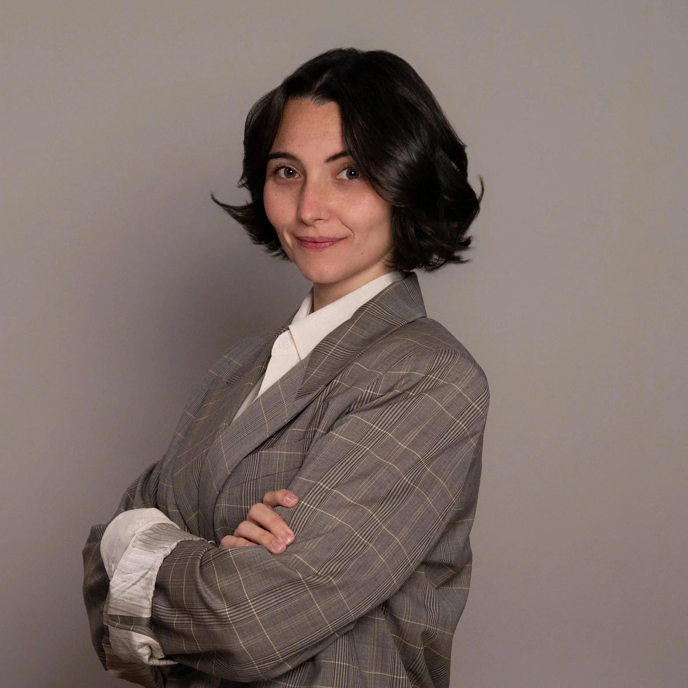 Professional headshot of a woman taken in a Richmond studio, showing a confident yet approachable expression with simple styling and natural tones.