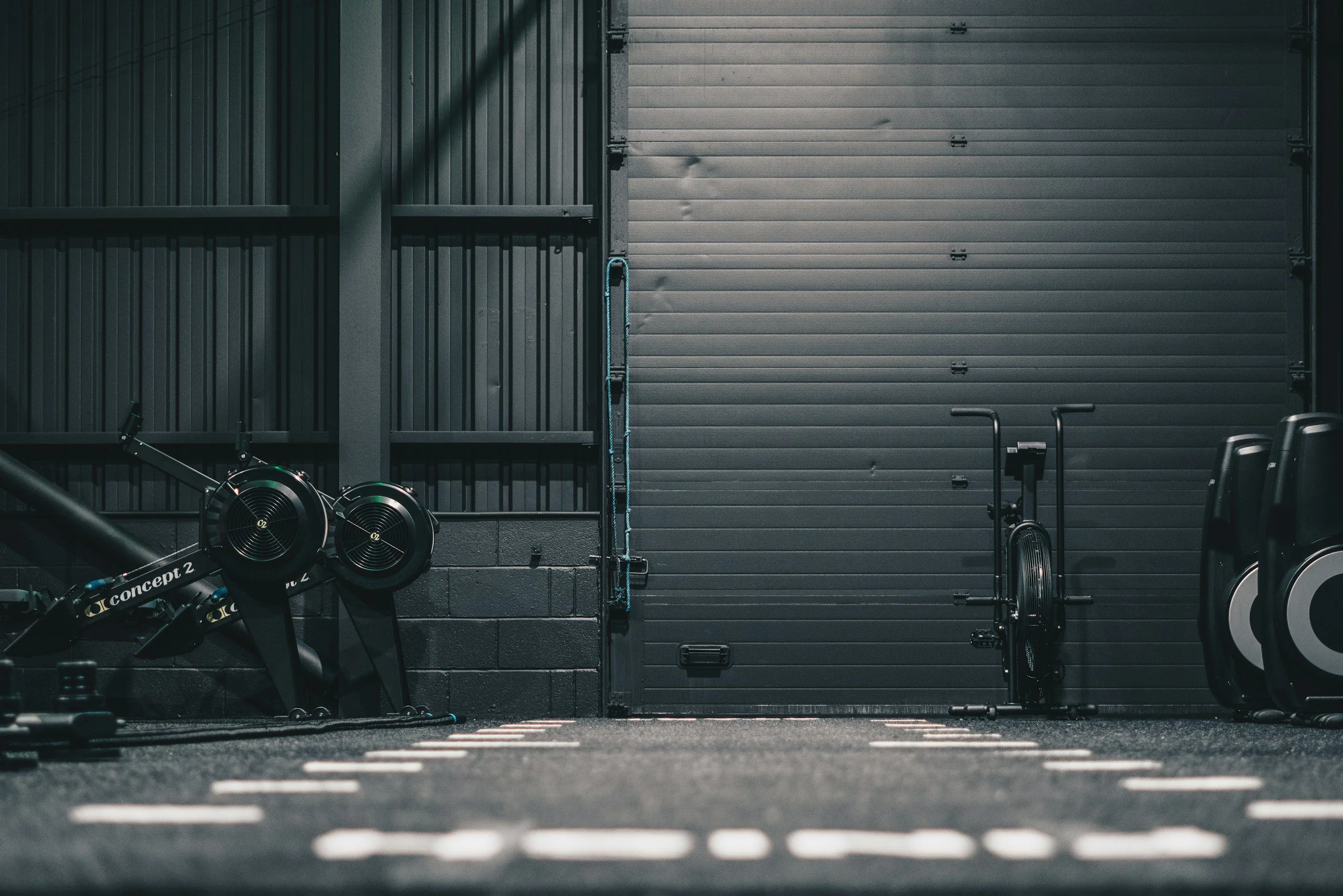 Strength and conditioning equipment inside a gritty training facility.