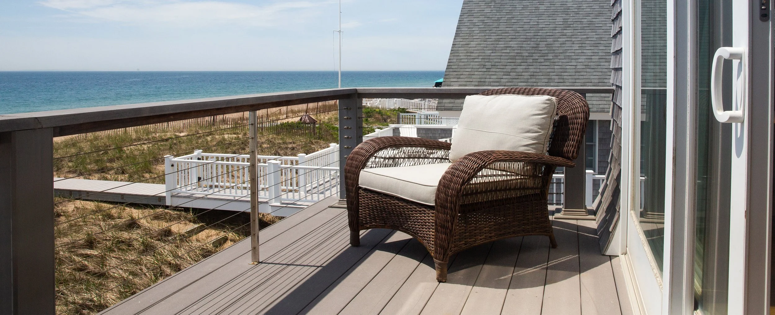 Chair on porch overlooking beach