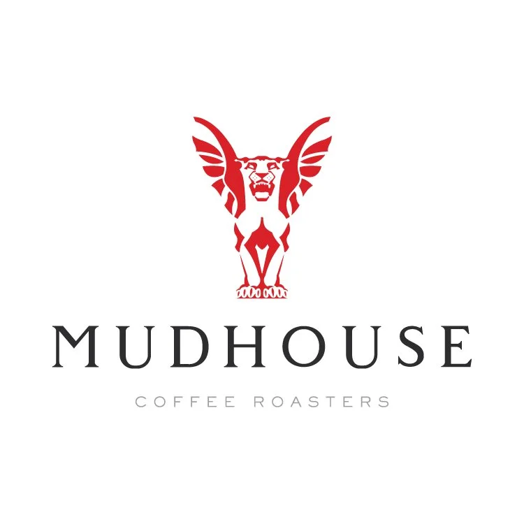 Logo of Mudhouse Coffee Roasters featuring a red stylized griffin with wings and feline face