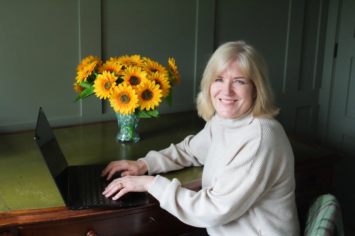 Anne Targett Health Coach at laptop smiling.jpg
