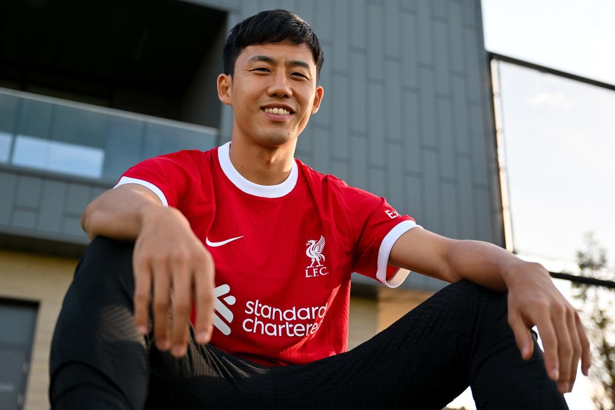 Person wearing a red Liverpool FC jersey sitting outdoors