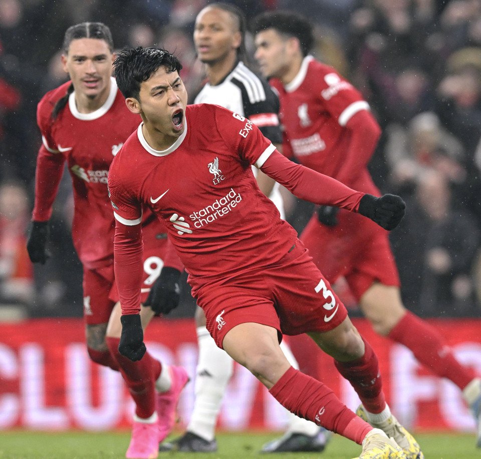 Soccer player celebrating goal in red Liverpool jersey