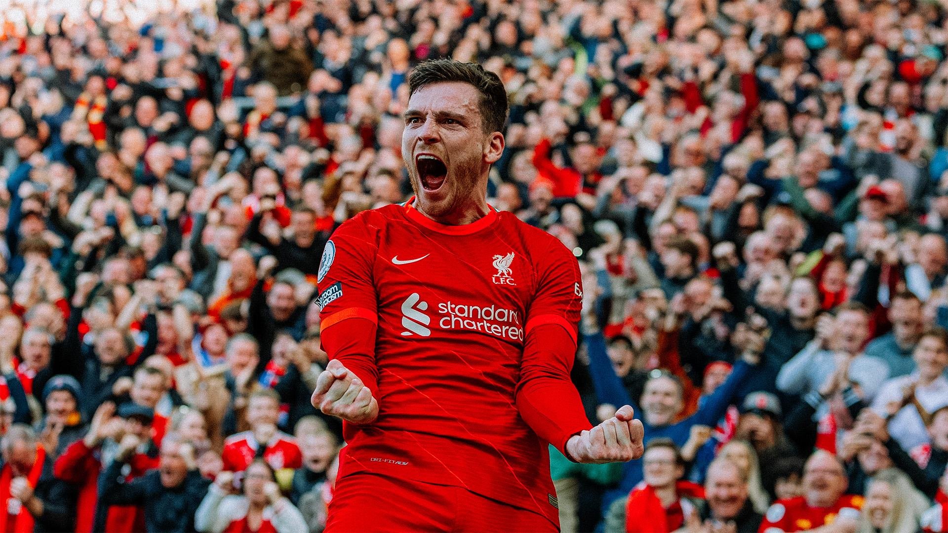 Soccer player in red jersey celebrating with fans in stadium background.