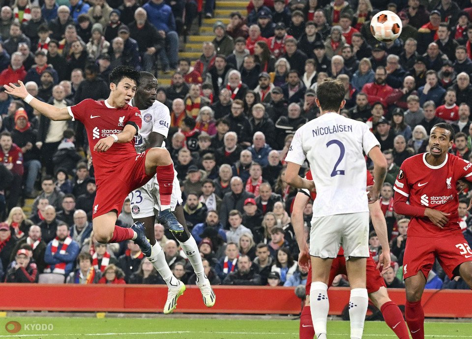 Soccer match with players in red and white jerseys competing for the ball
