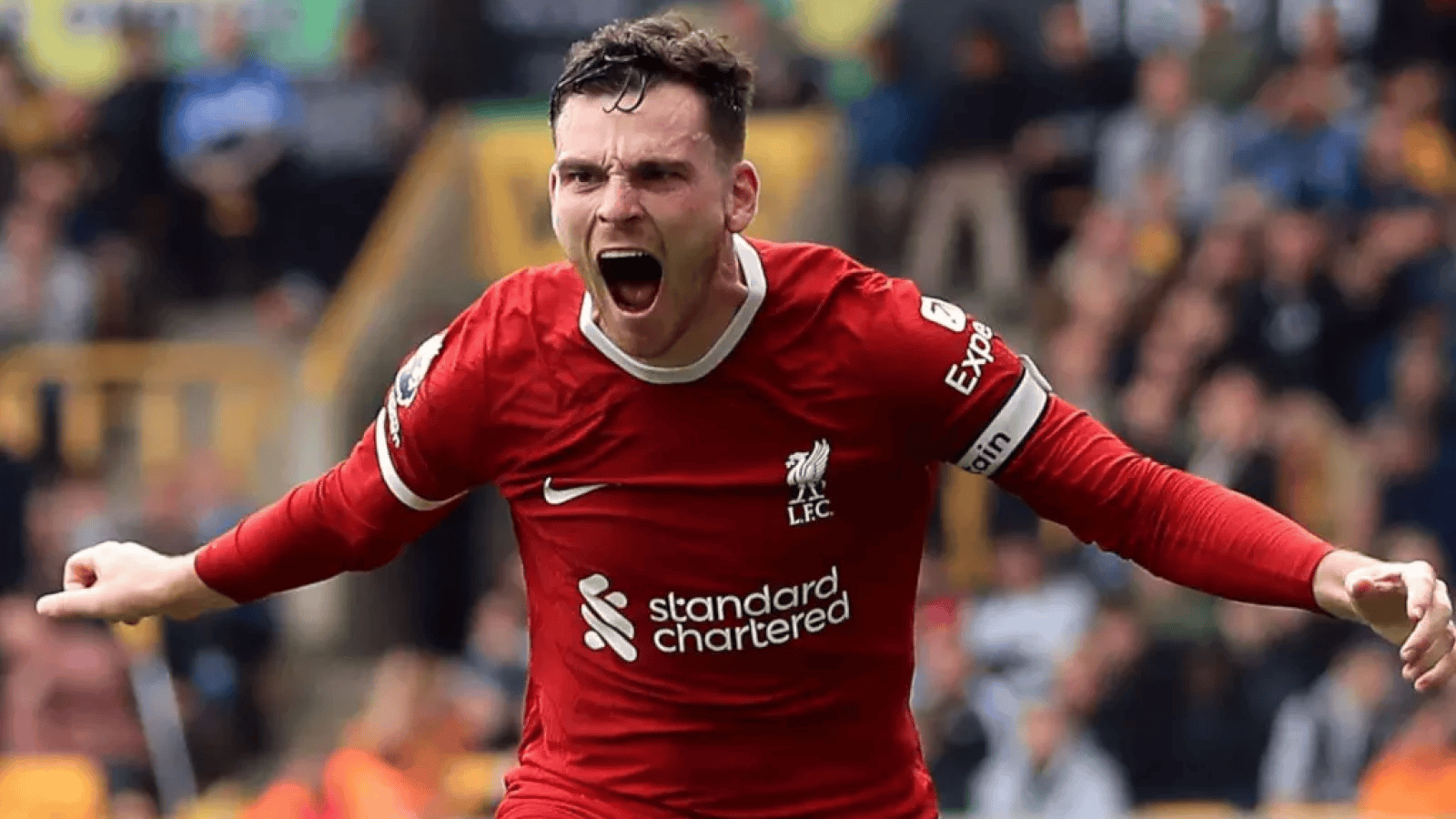 Soccer player in red Liverpool jersey celebrating during a match.