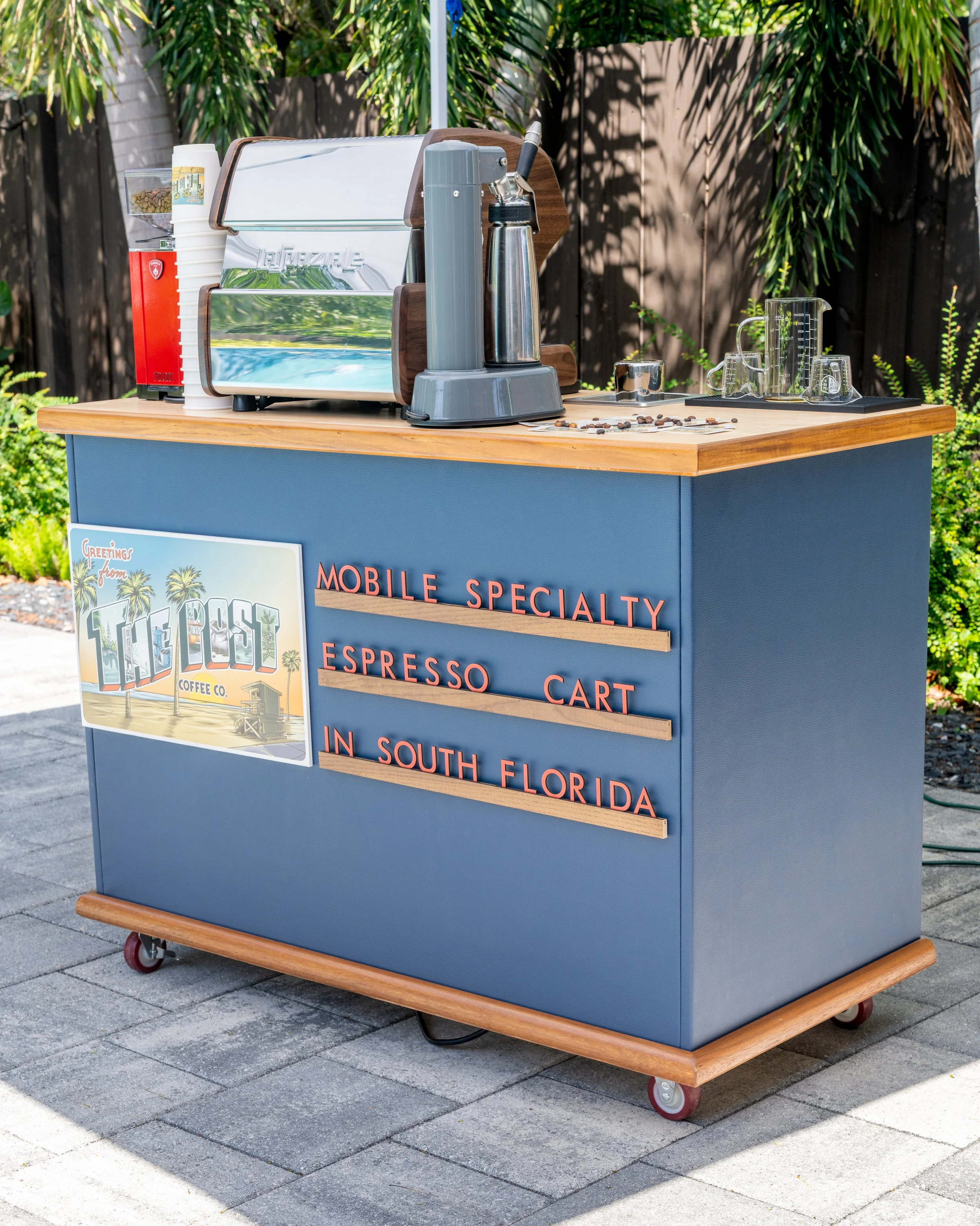 Mobile espresso cart in South Florida with coffee equipment and signage.