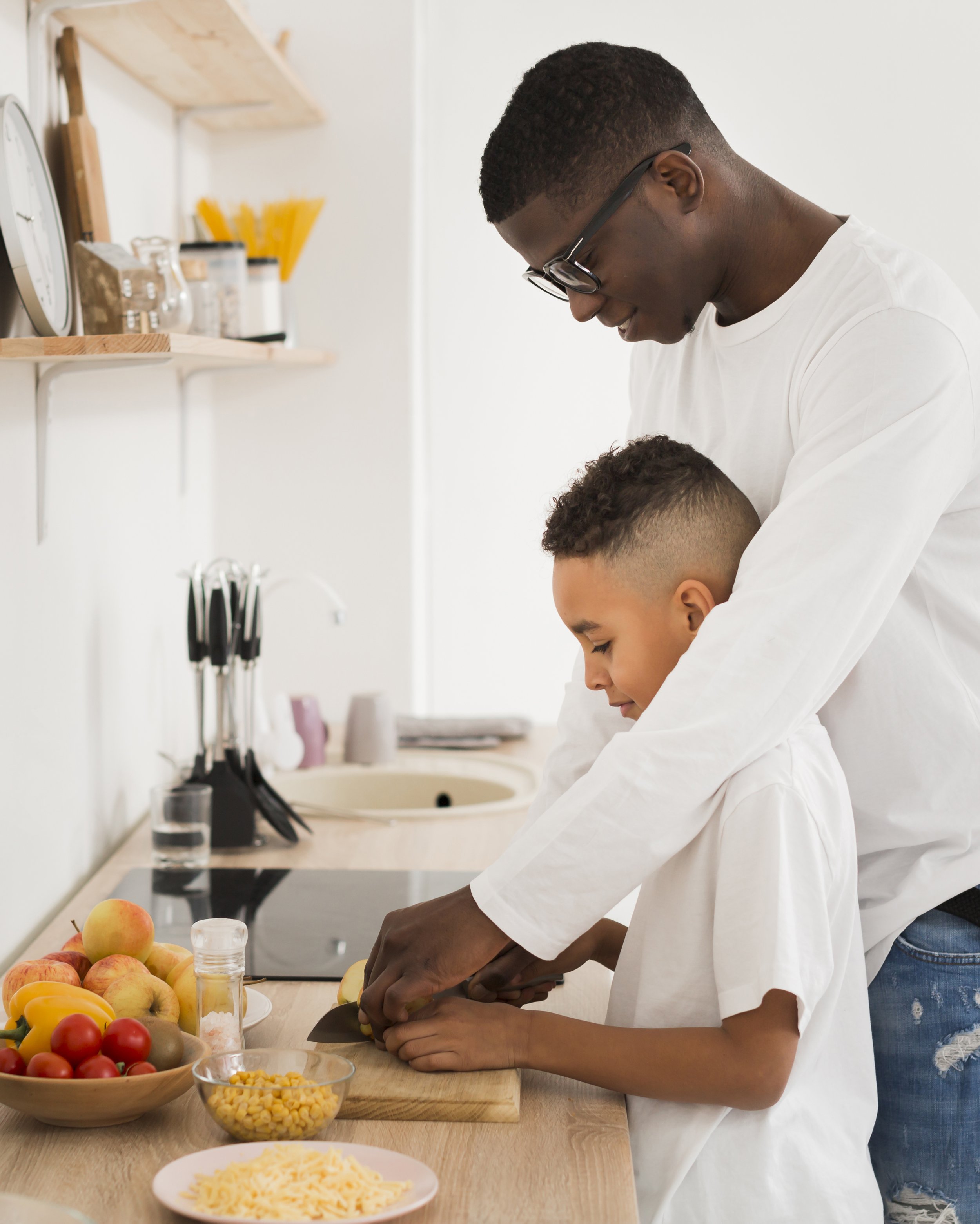 side-view-father-teaching-son-how-cut-fruits.jpg
