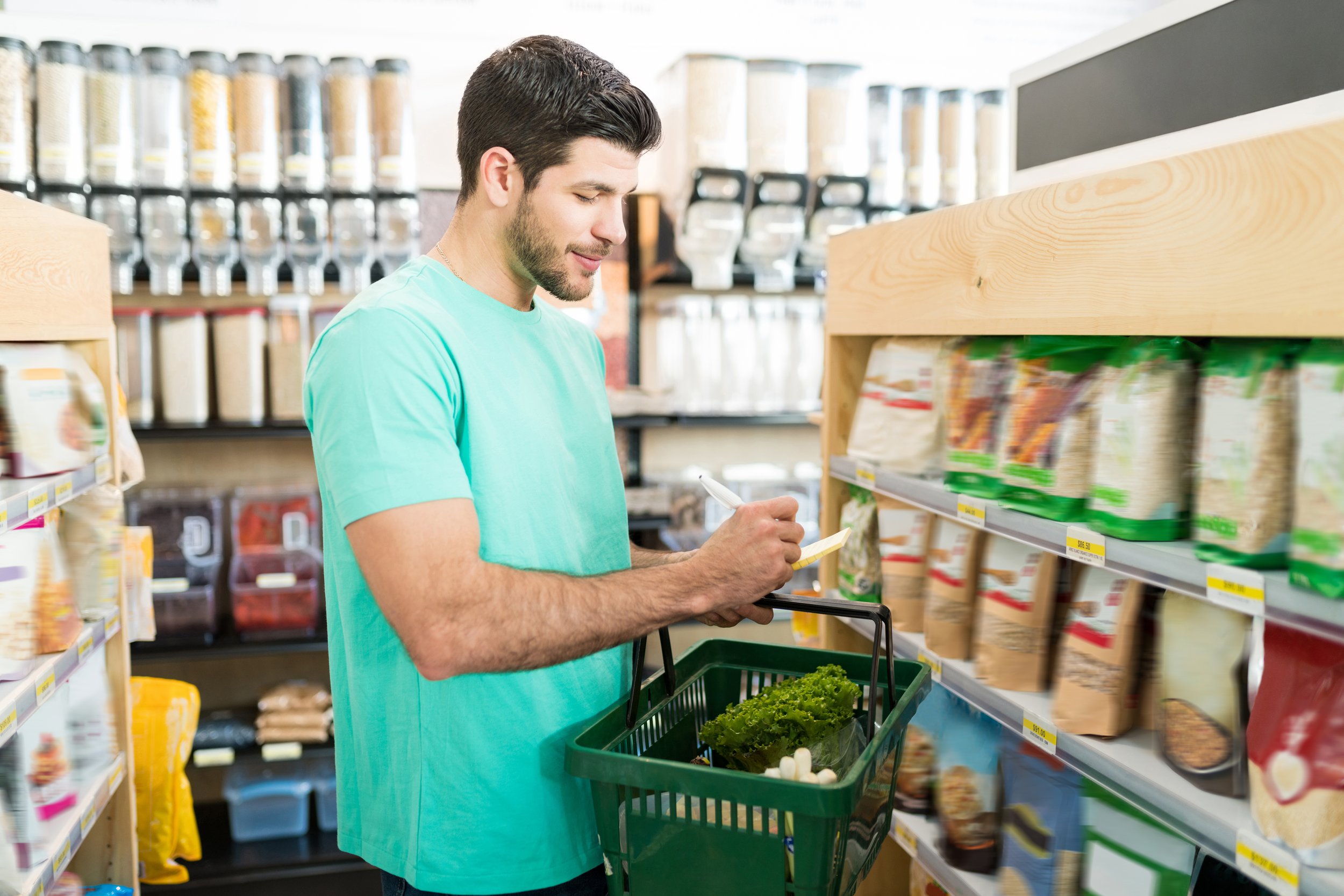 smiling-young-man-checking-shopping-list-supermarket.jpg
