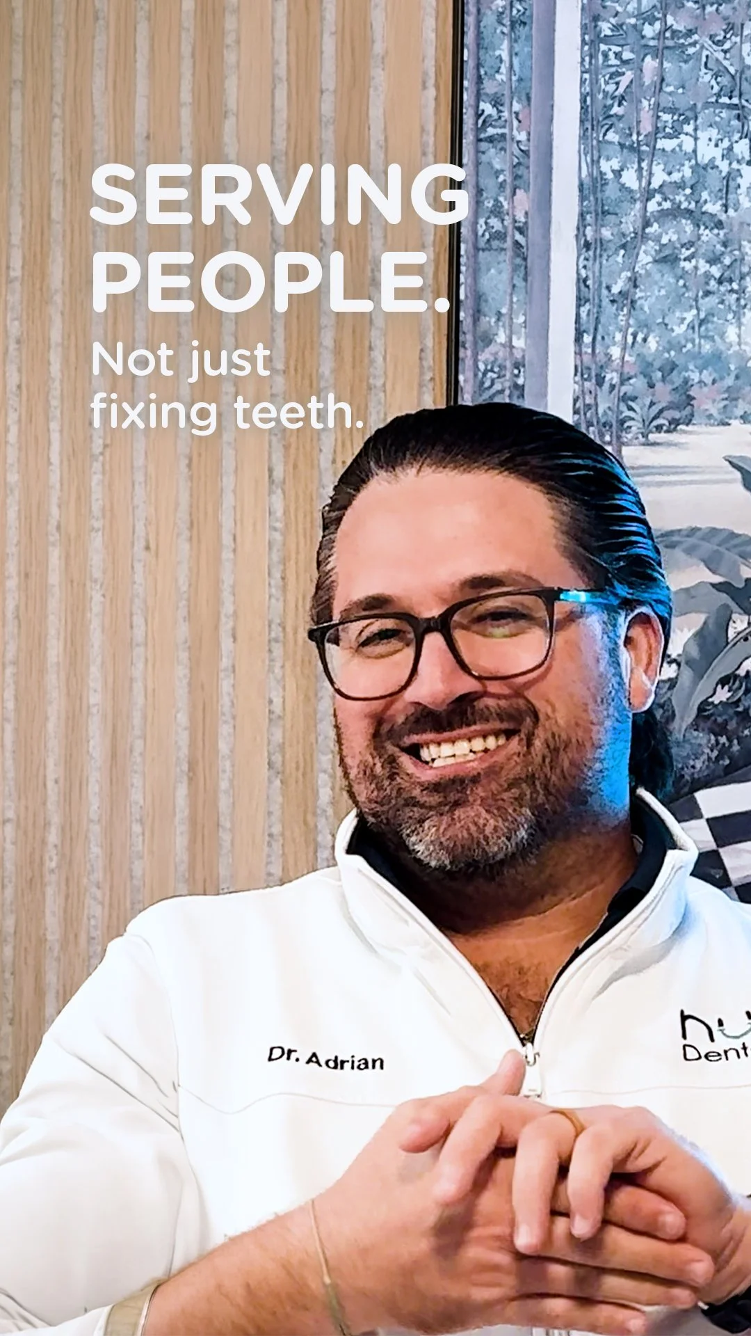 Dr. Adrian Gonzalez smiling at Nuvo Dental Arts in Miami emphasizing patient care and serving people beyond dentistry