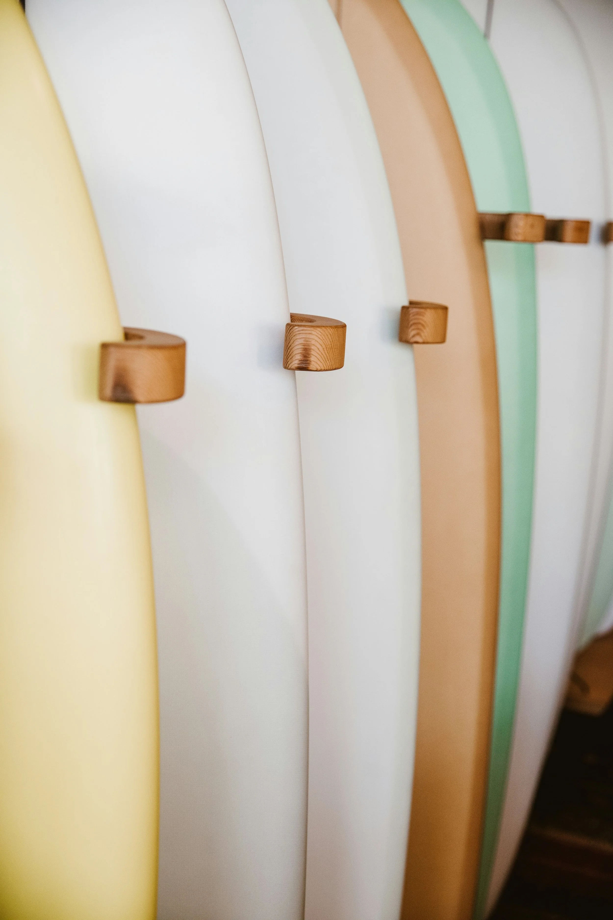 Colorful surfboards with wooden fins