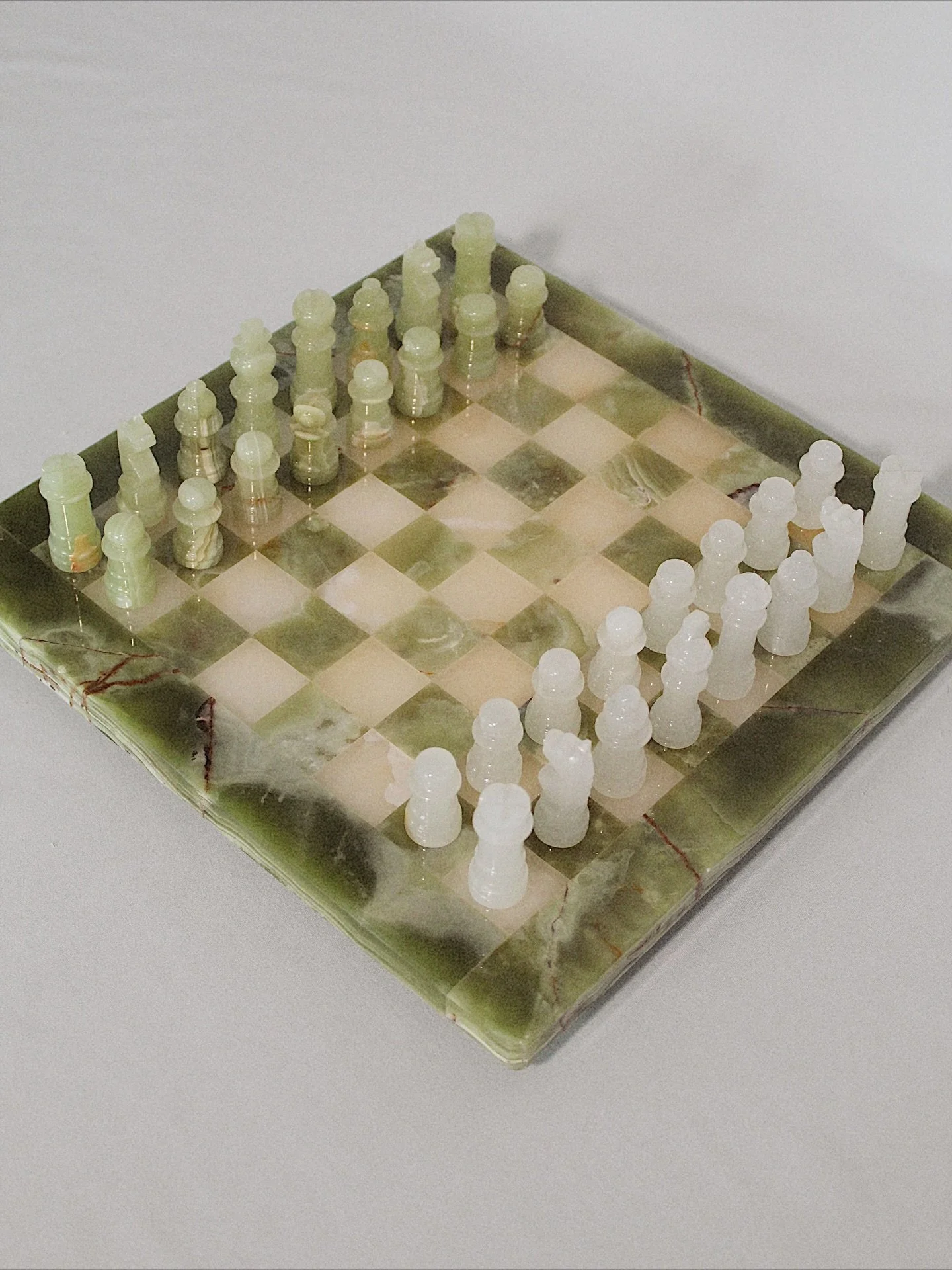 Handmade in Crete, Greece, this vintage carved onyx chess set is the centerpiece every room needs. Intense coloring and veining paired with sleek shaped pieces makes this one of the most unique sets I have ever come across. Perfect condition. Tones o