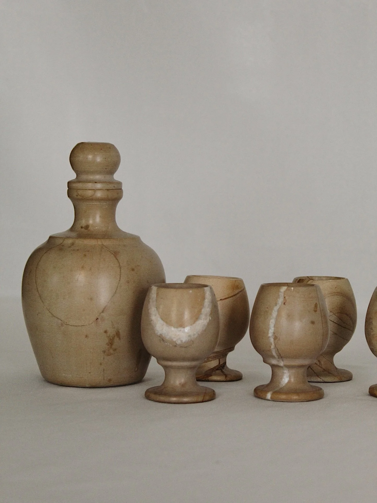 Vintage stone decanter and petite goblet set in beautiful condition. Decanter with stopper measures at 7&rdquo; and goblets at 3&rdquo;. Would look gorgeous on open shelving in a kitchen space.
$85 

Please head to CheckmateHomeInteriors.com to purch