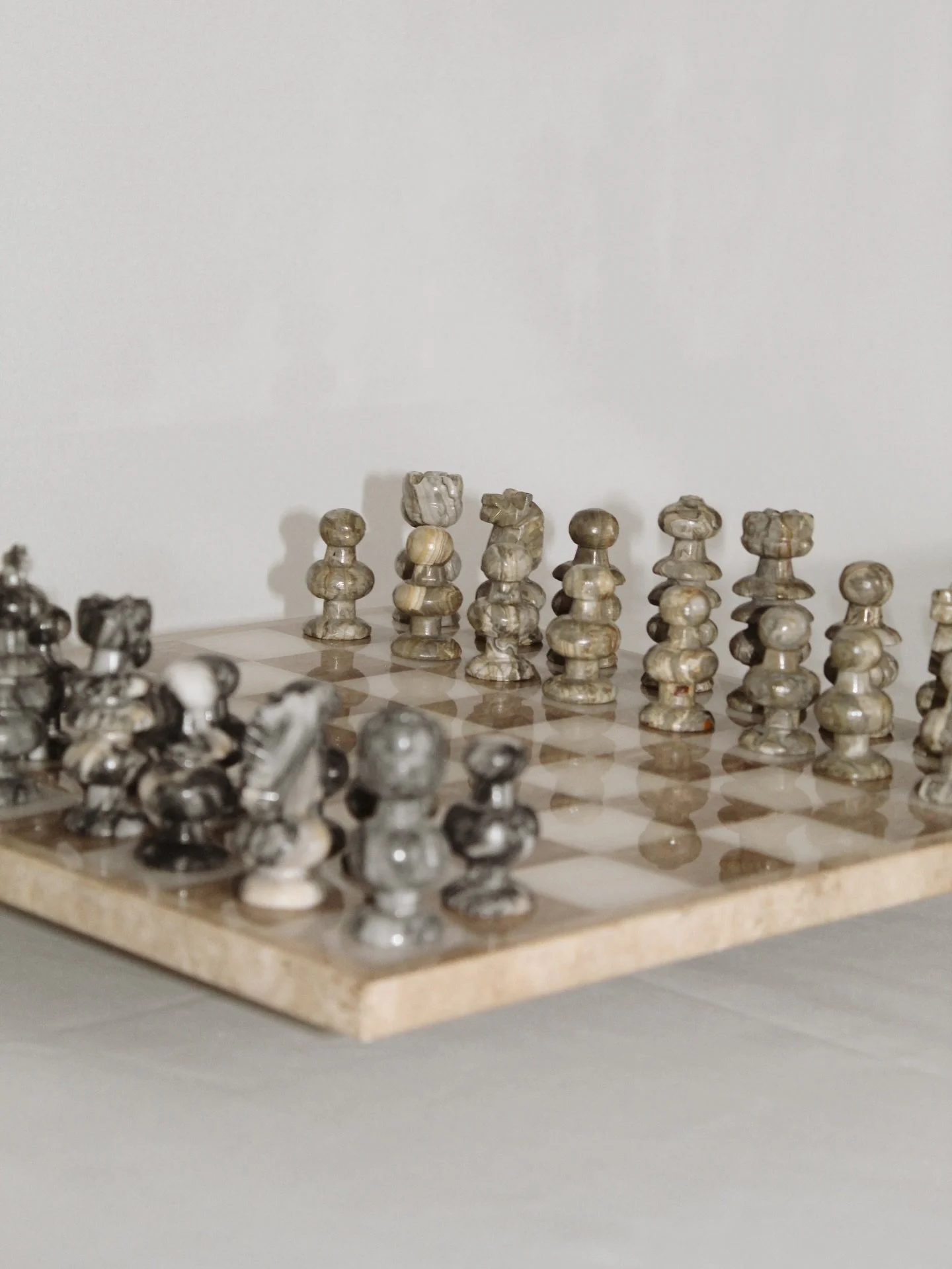 Vintage neutral marble and onyx chess set with carved marble chess pieces. Perfect size for any space measuring at 13.5&rdquo;. Great condition yet has some wear consistent with age- two small chips on the board as well as a repaired dark king and a 