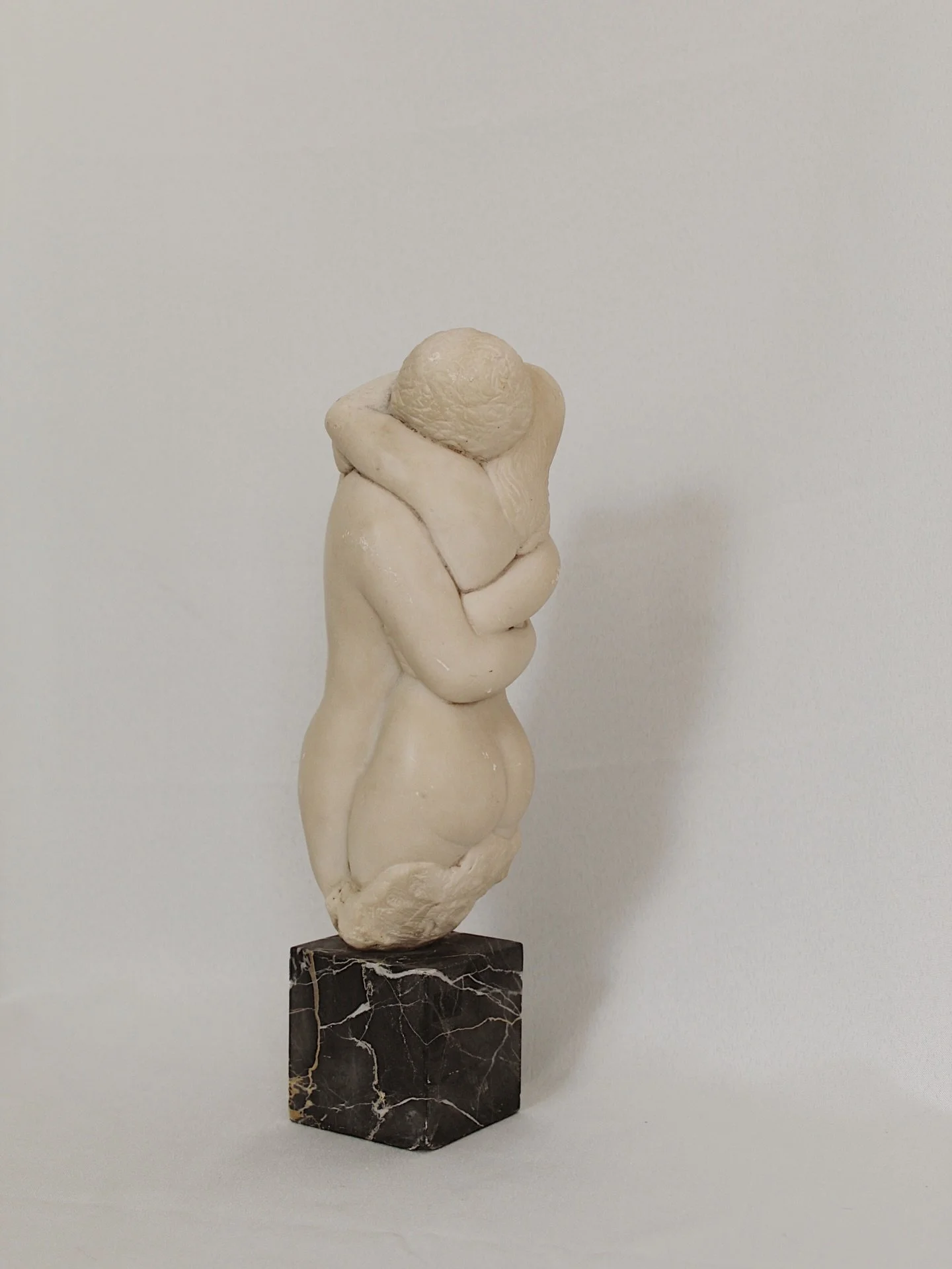 Vintage sculpture by Peggy Mach titled, &ldquo;Embracing Nudes,&rdquo; signed and dated 1971. Made of a stone and resin mix atop a solid marble base. Wear consistent with age- a few small chips and scratching throughout the bodies. The base has a chi