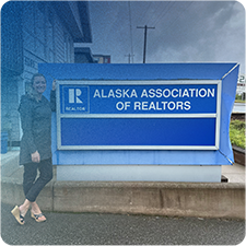 Jennifer Thompson in front of the Alaska Association of Realtors sign
