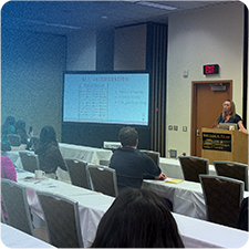 Jennifer Thompson teaching a seminar to members of a company