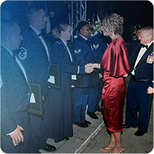 Jennifer Thompson shaking the hands of military members