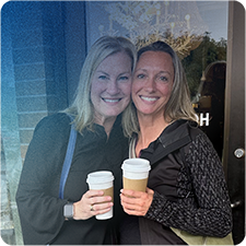 Two woman hugging after connecting over coffee
