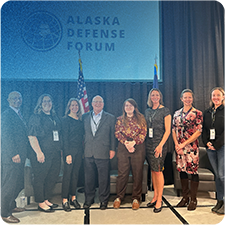 Jennifer Thompson posing with members of the Alaska Defense Forum