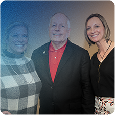 Jennifer Thompson standing with a blonde haired woman and white haired man.