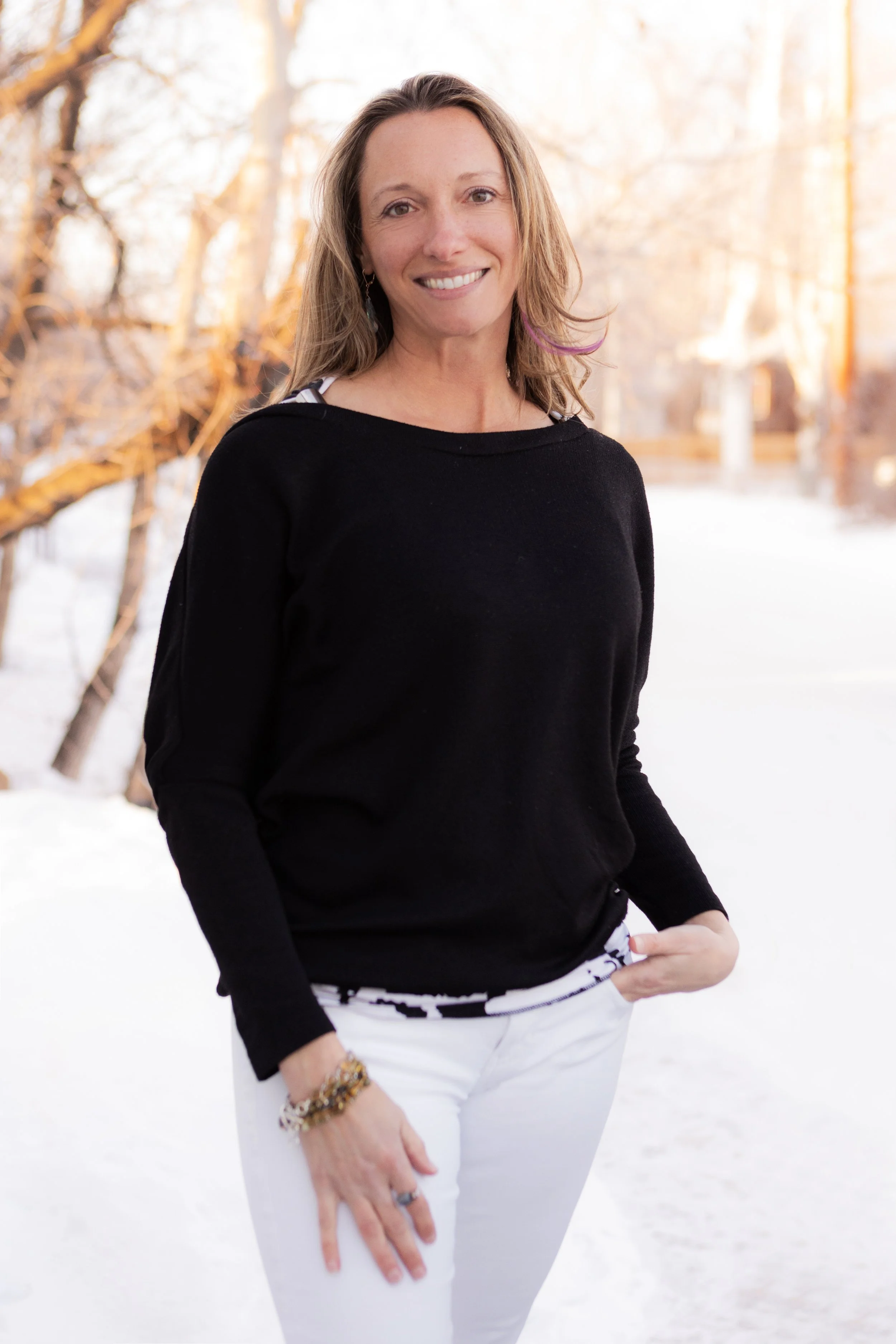 Jennifer Thompson standing in snow with trees in the background.