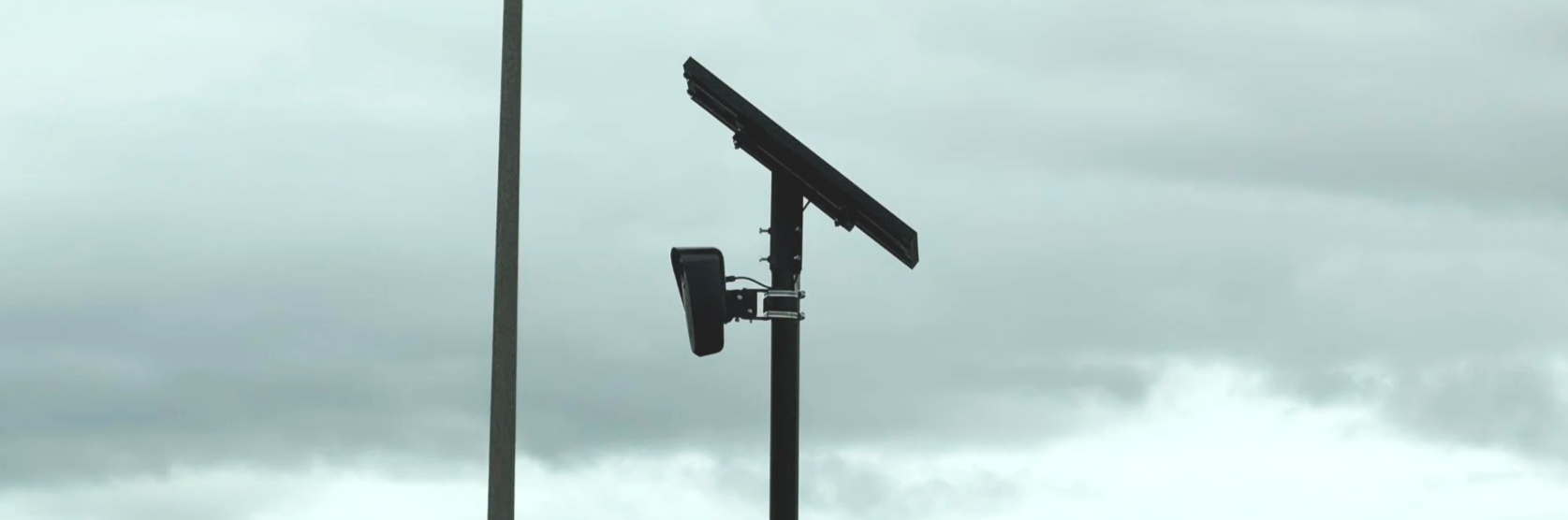 A Flock Safety camera at Legends in Sparks photographed in 2025. Above the camera is a solar panel.