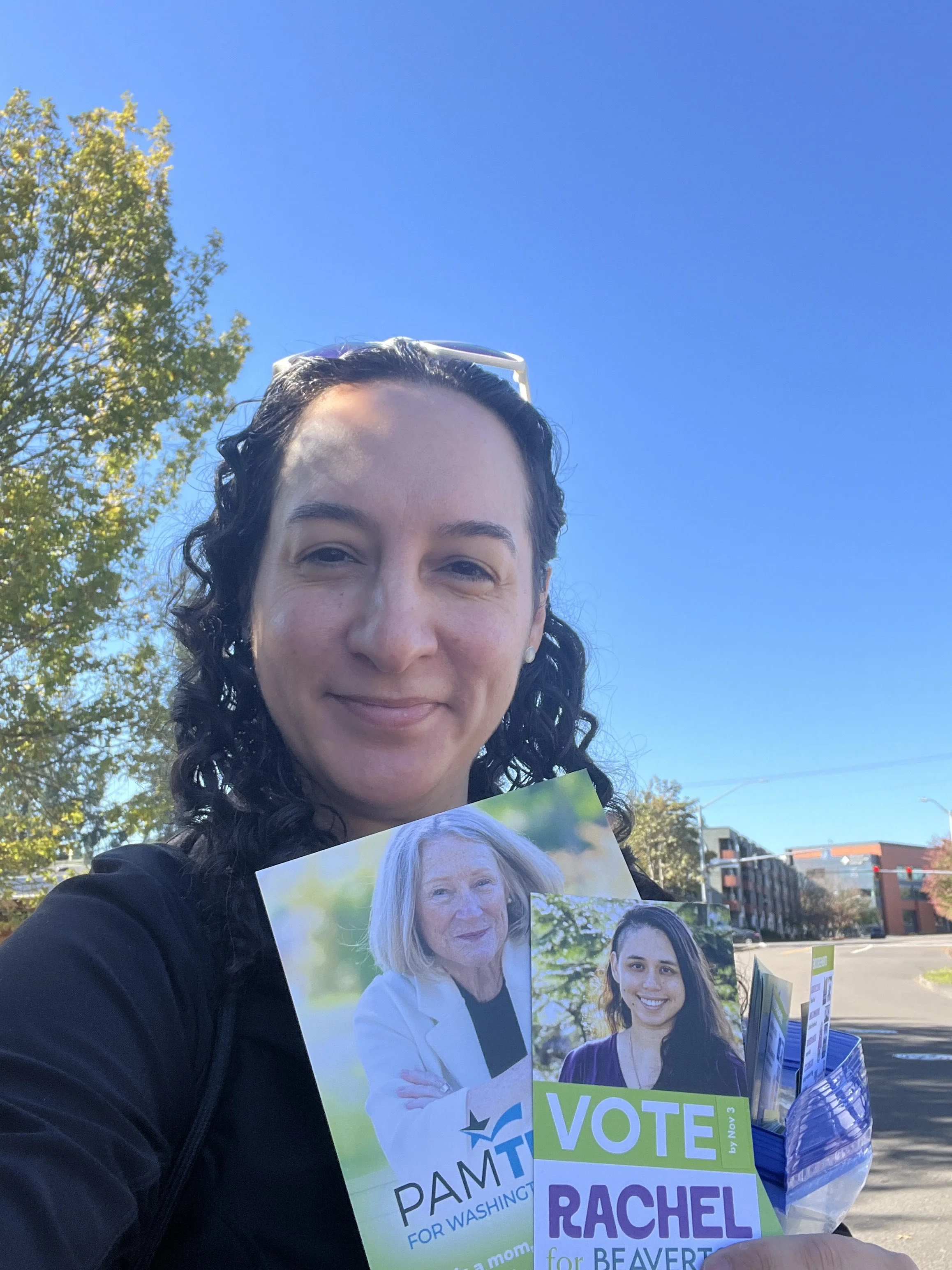 A selfie of Felicita holding printed materials for Pam and Rachel's campaigns