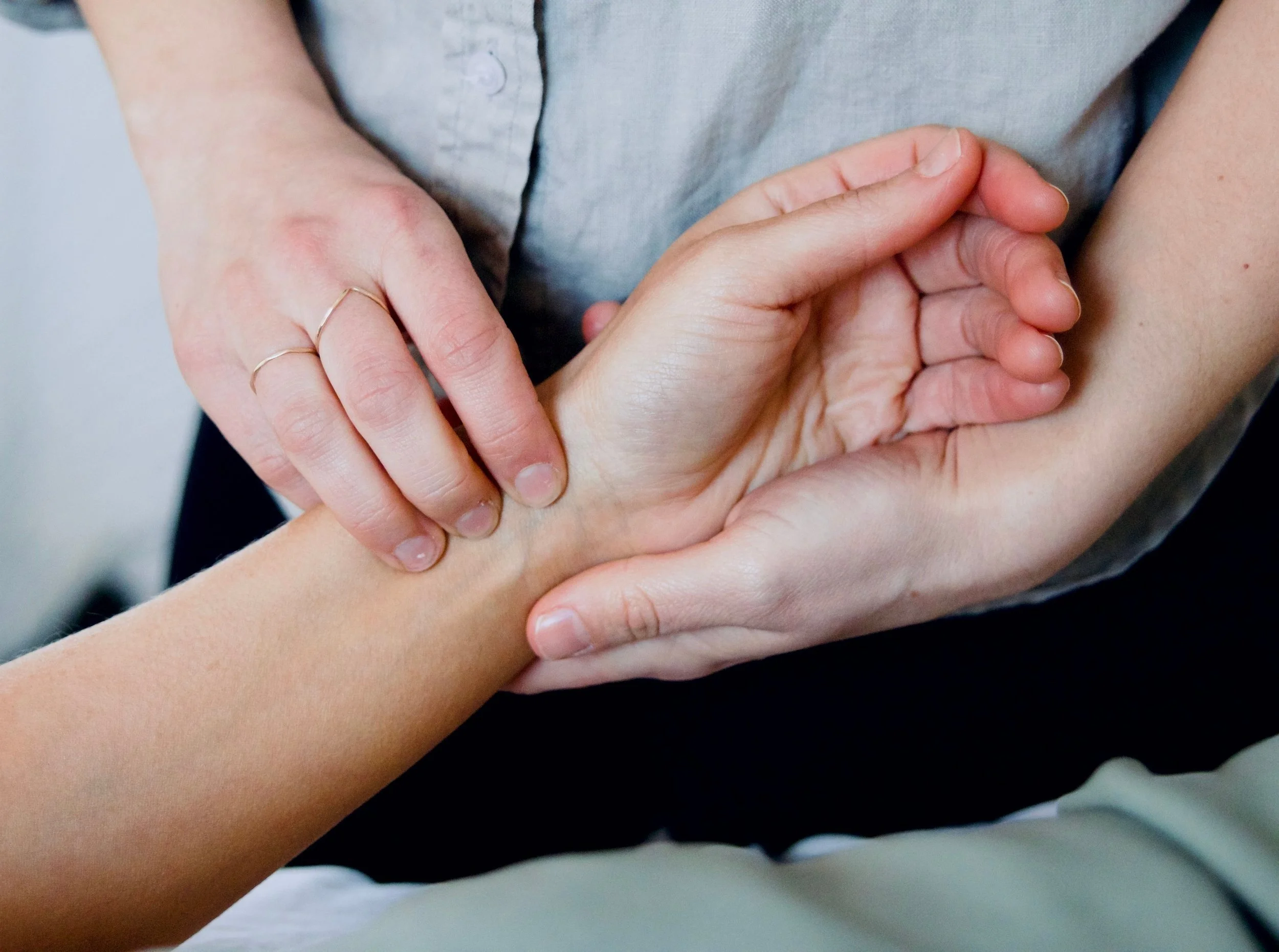 an acupuncturist taking the radial pulse of a patient