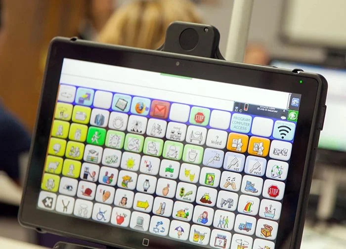 Tablet screen with colorful icon grid for communication aid