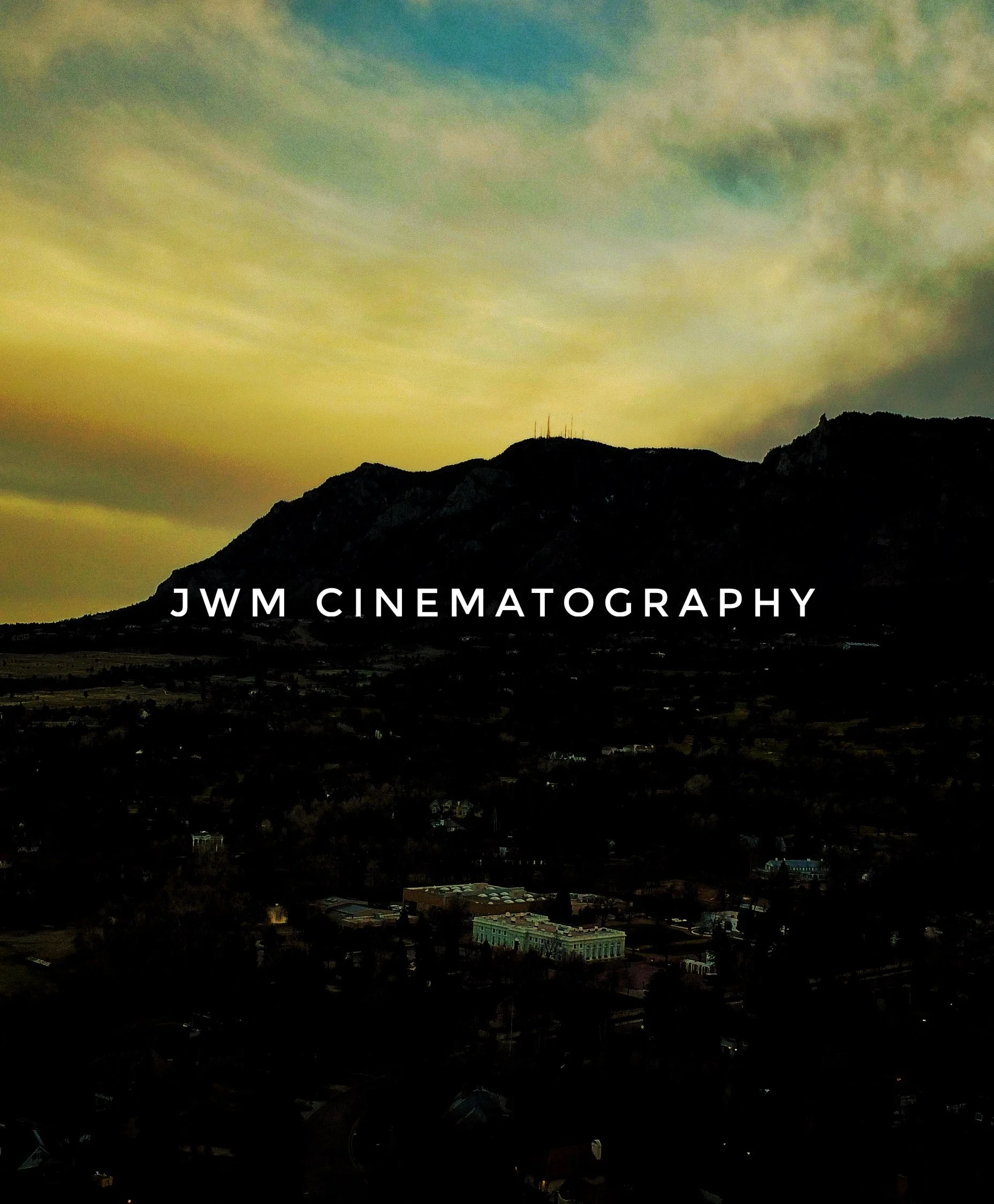A scenic view of a silhouette of mountains against a sunset sky with the text 'JWM Cinematography' overlaid in the center.